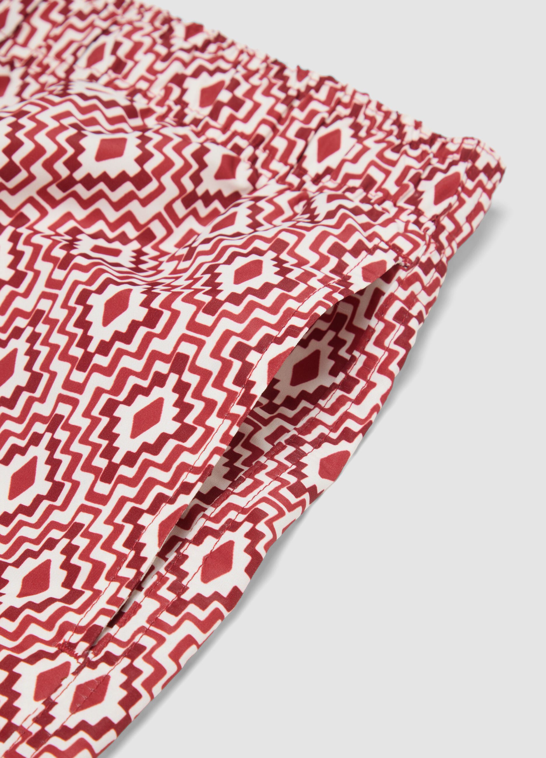 Red swim shorts with geometric print