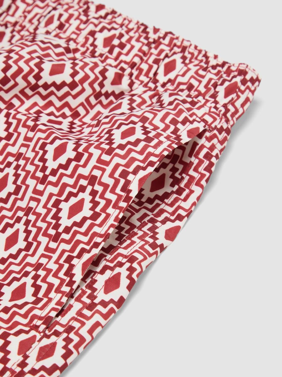 Red swim shorts with geometric print_1