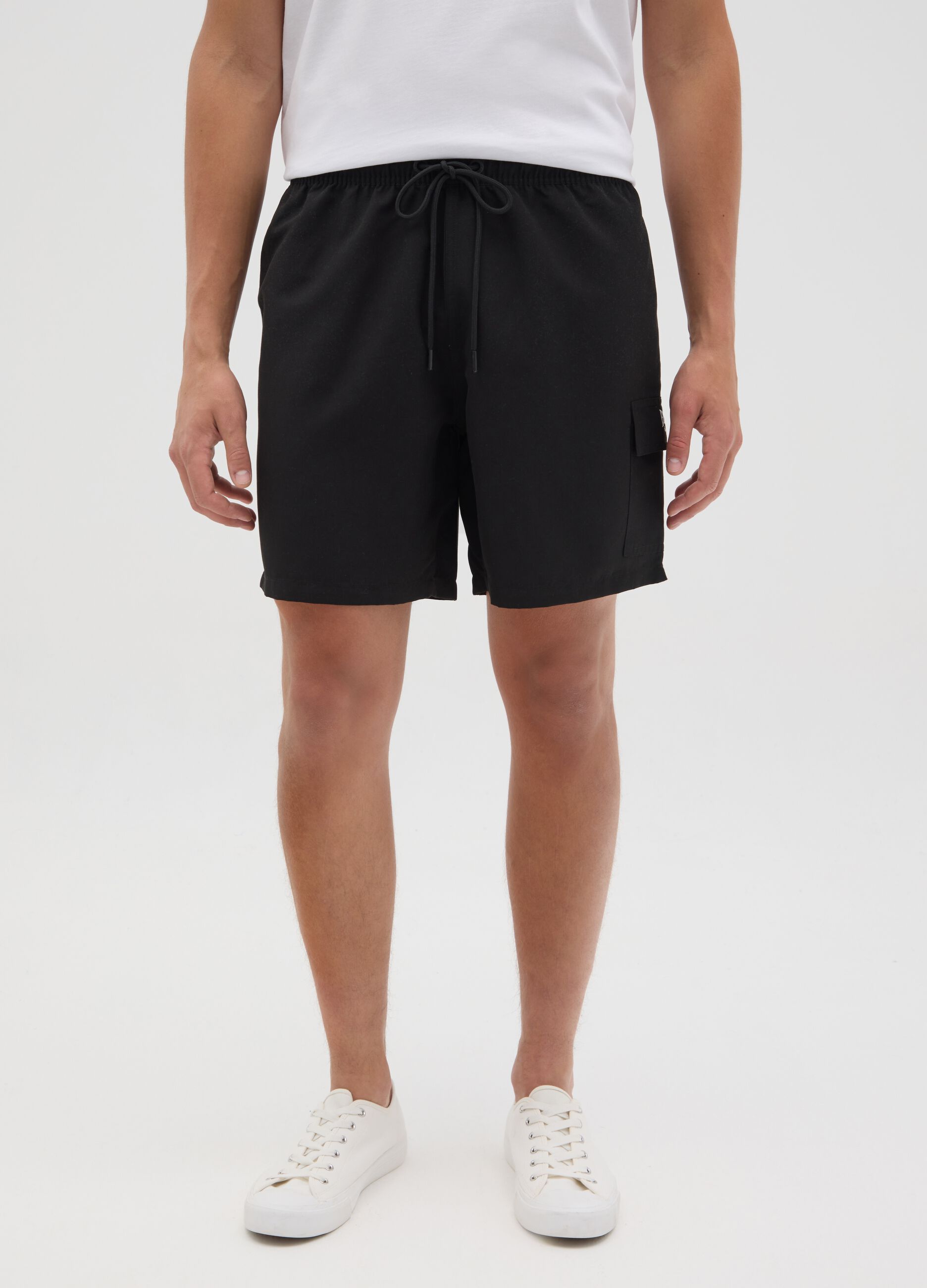 Black swimming trunks with logo print