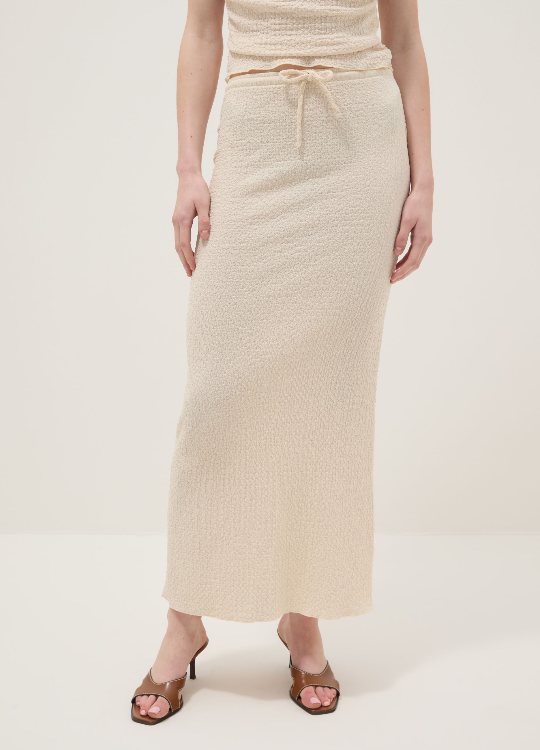 Beige long skirt in stretchy textured fabric
