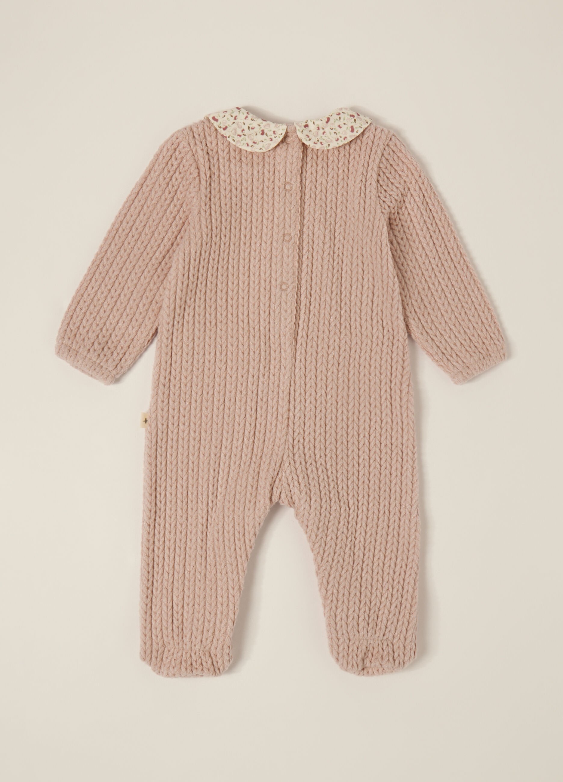Pink knitted baby romper with floral collar