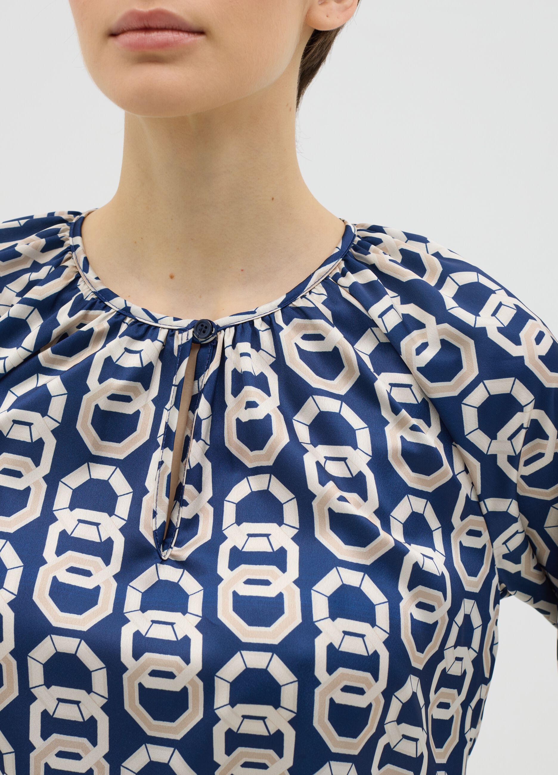 Blue long-sleeved blouse with geometric print
