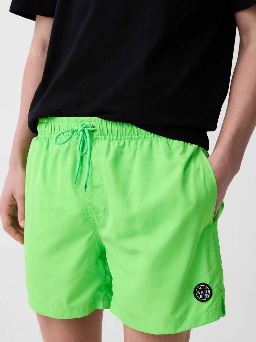 Fluorescent swimming trunks with logo patch_1