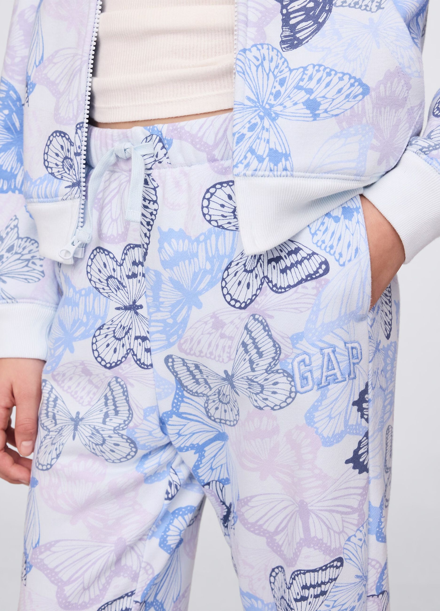 Light blue joggers with drawstring, logo embroidery and butterflies print