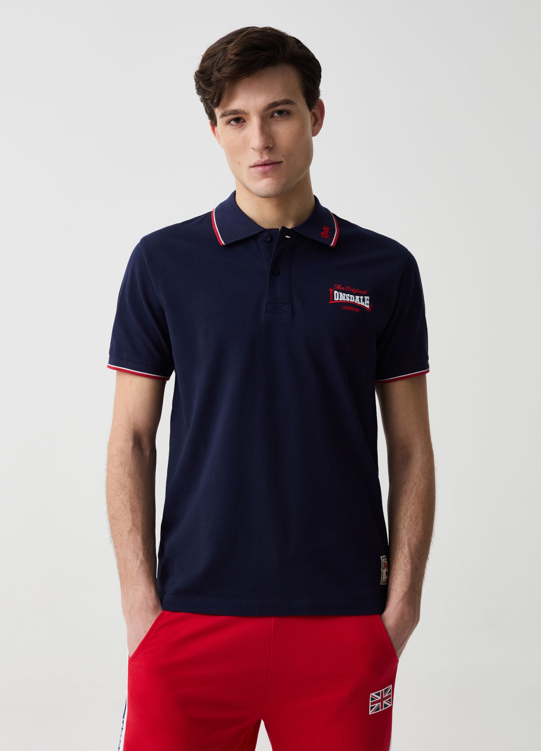 Polo shirt with striped edging and logo embroidery