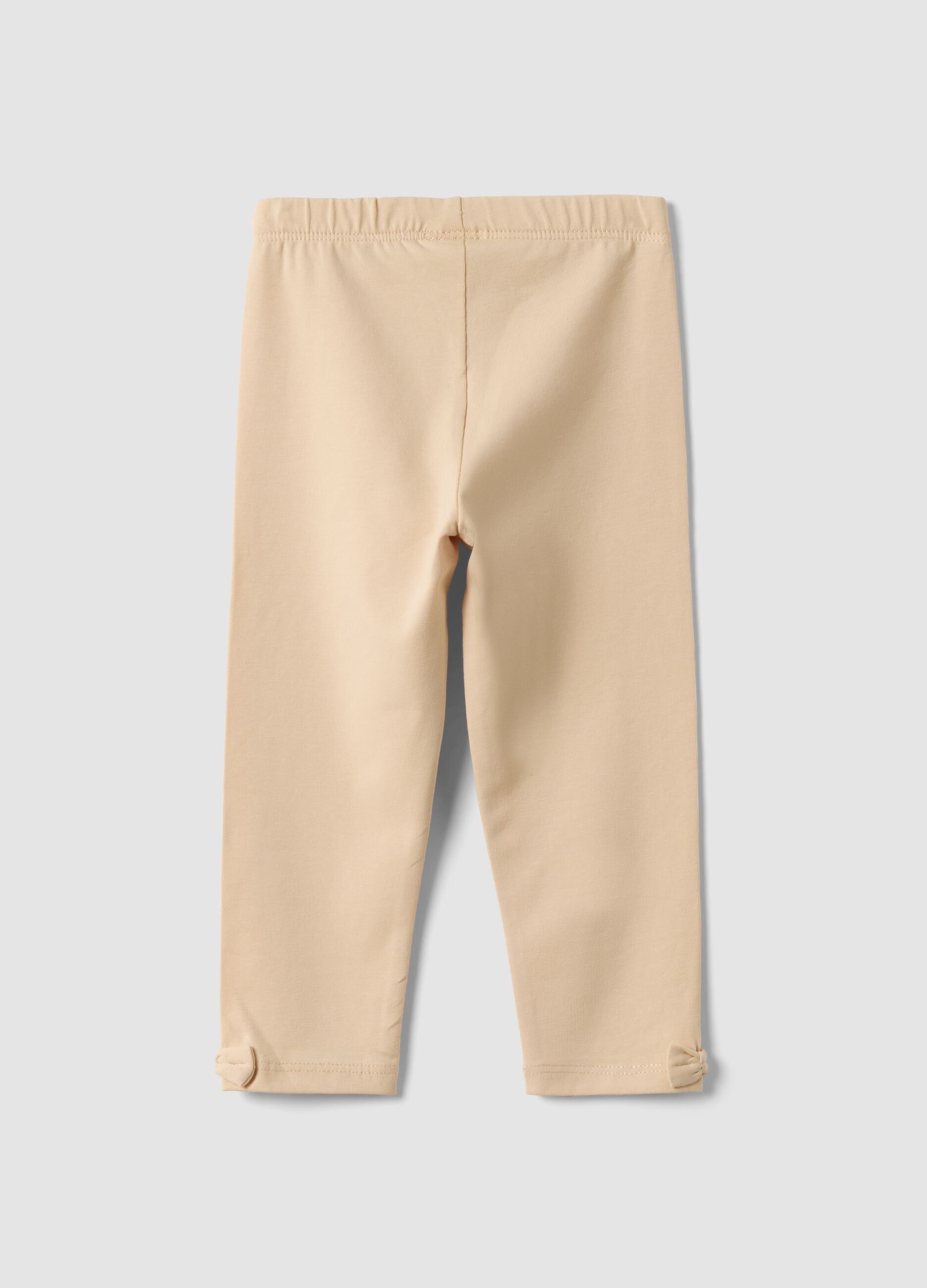 Beige stretch organic cotton leggings with bows for baby girl