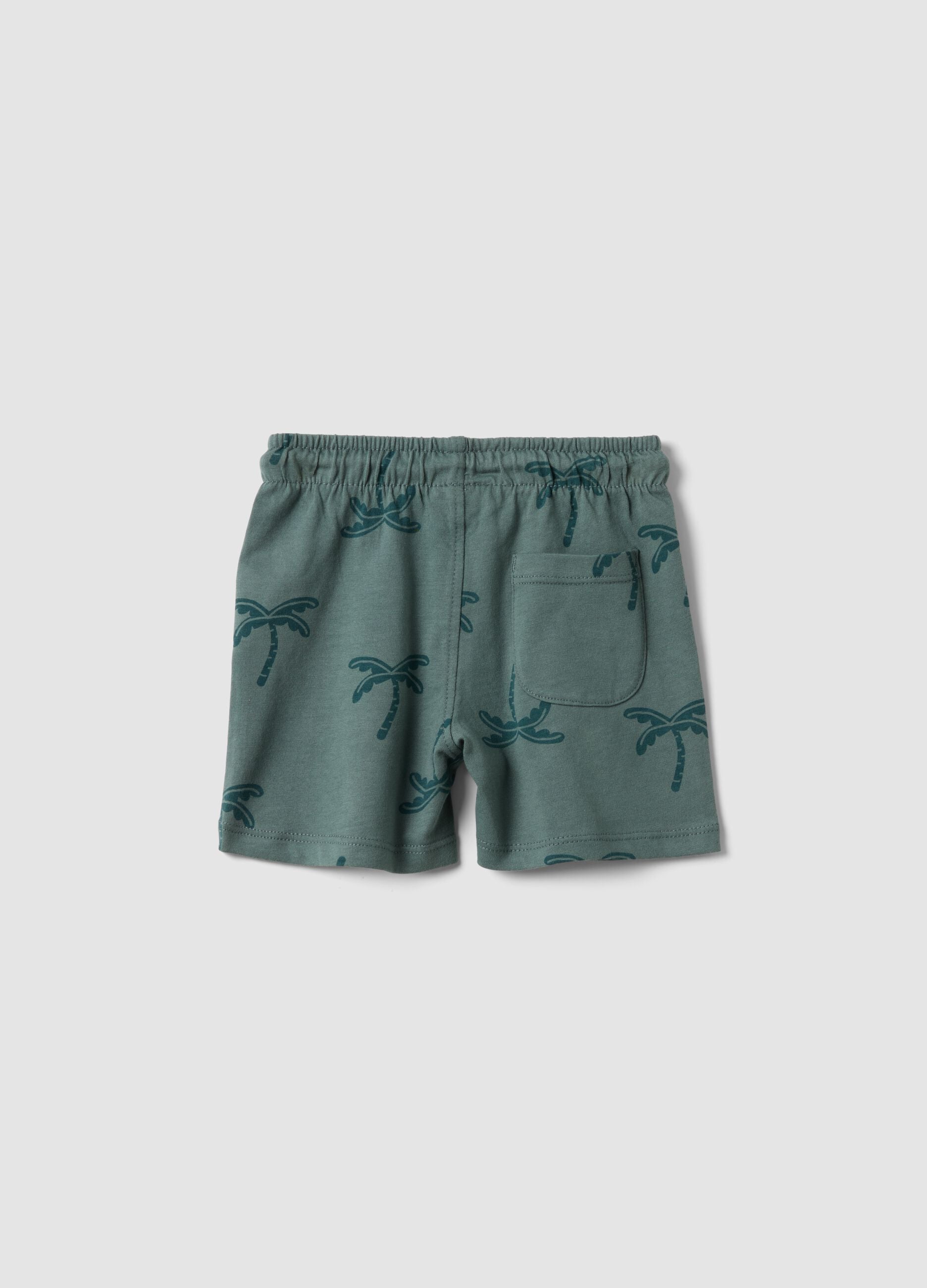 Green organic cotton shorts with palm print