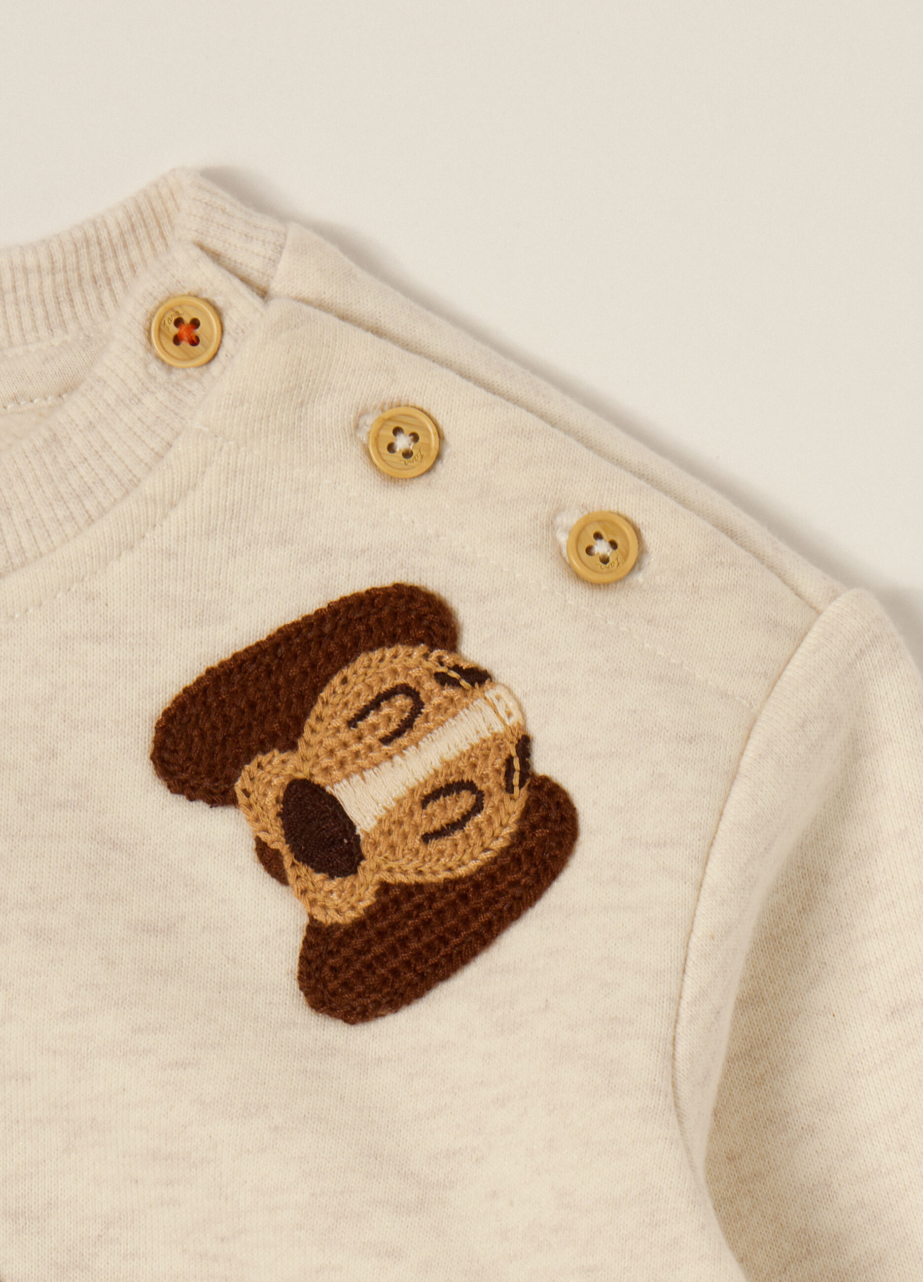 Beige sweater with dog appliqués