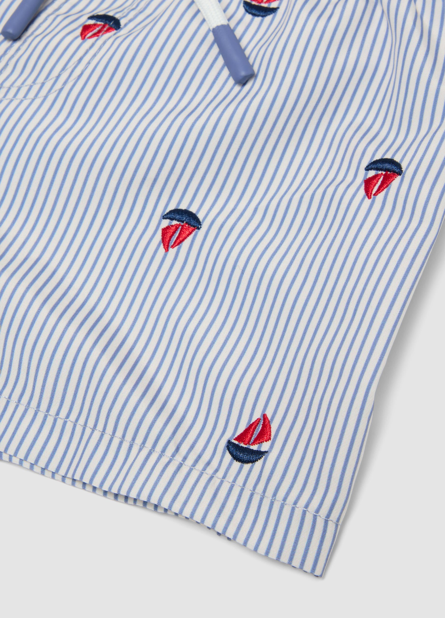 Blue striped baby swim shorts with embroidered boats