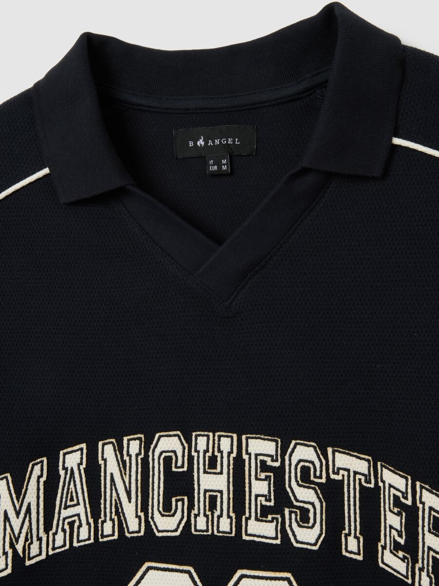 Polo sportiva in puro cotone nero vestibilità oversize_5