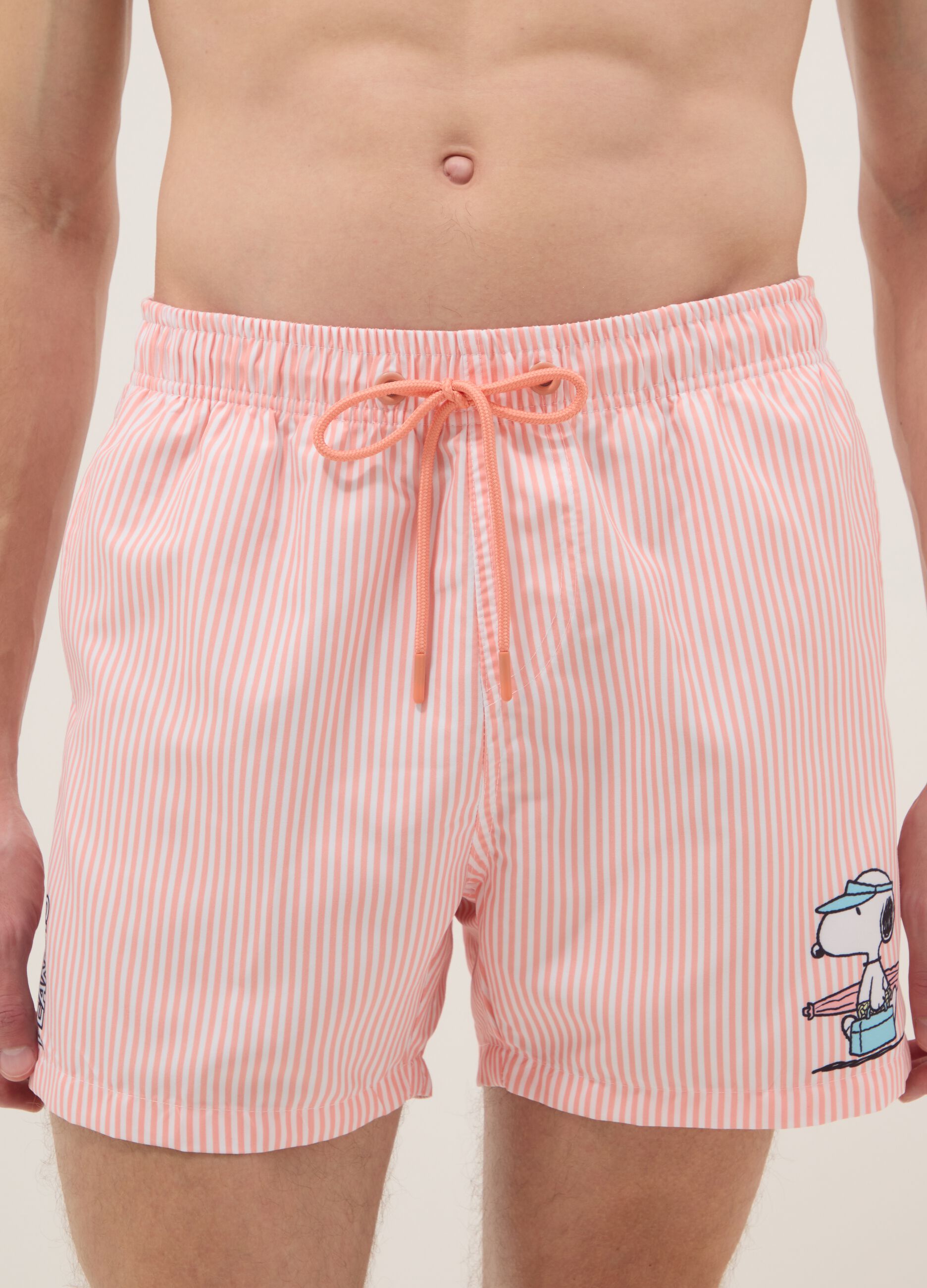 White and pink striped swim trunks with Peanuts print