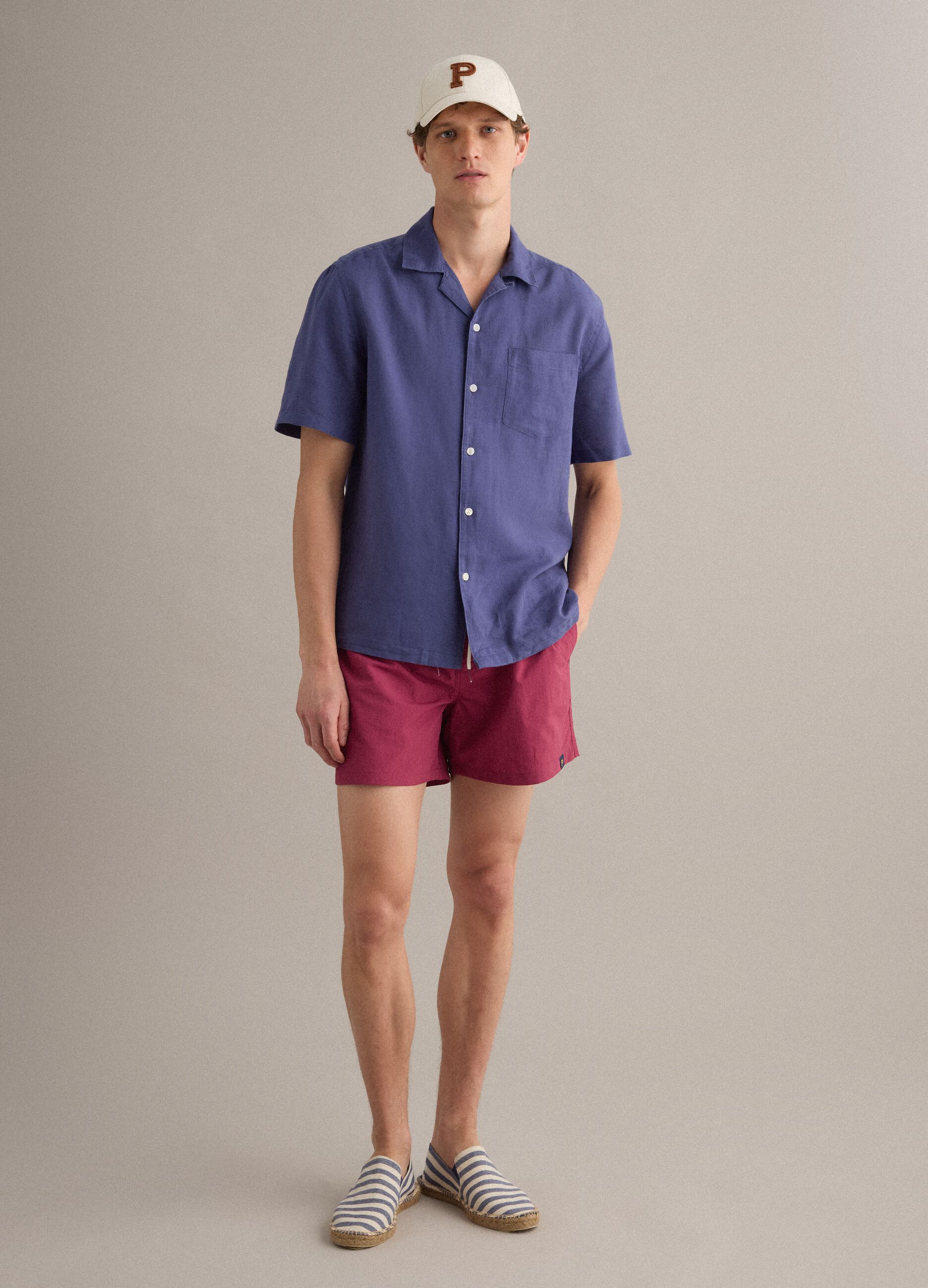 Red swim shorts with elasticated waistband and drawstring