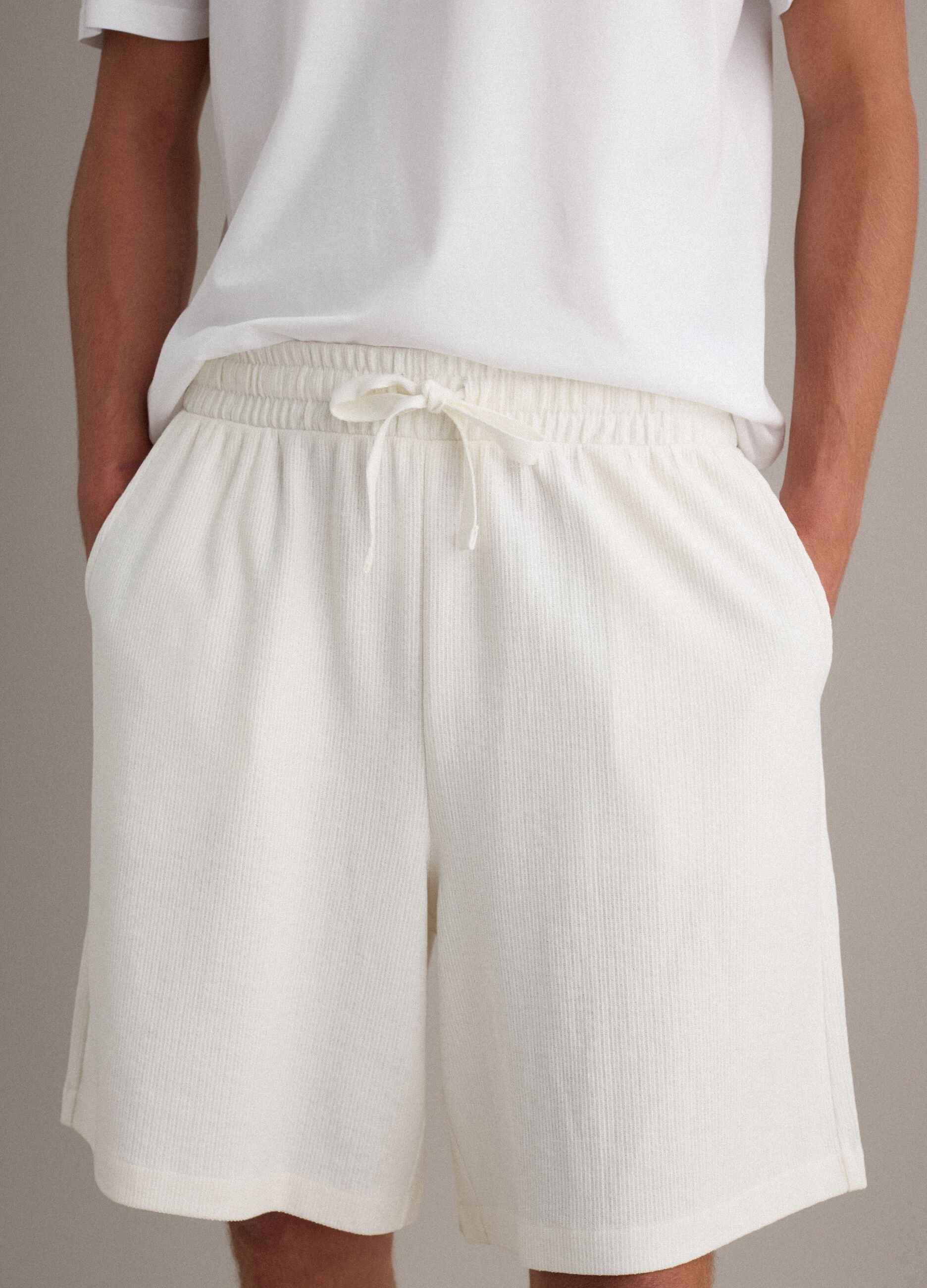 White cotton-blend jogger shorts with drawstring, relaxed fit
