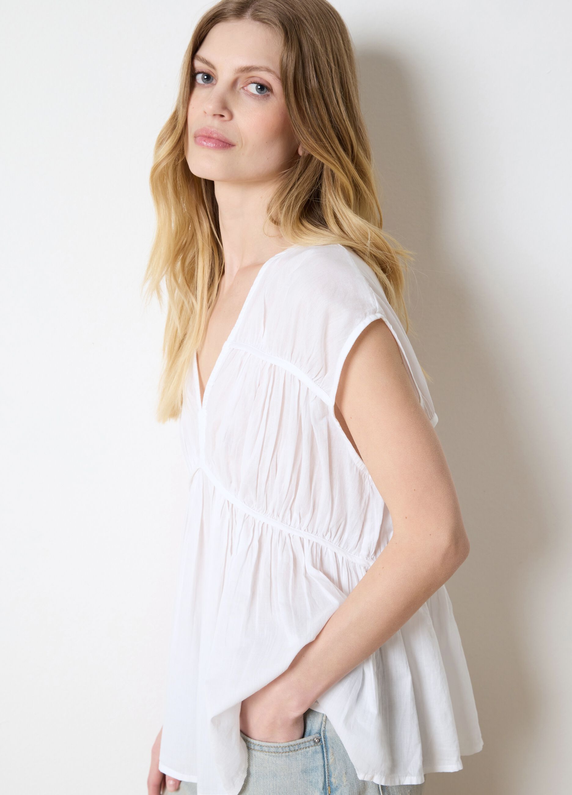 White sleeveless cotton blouse with gathering