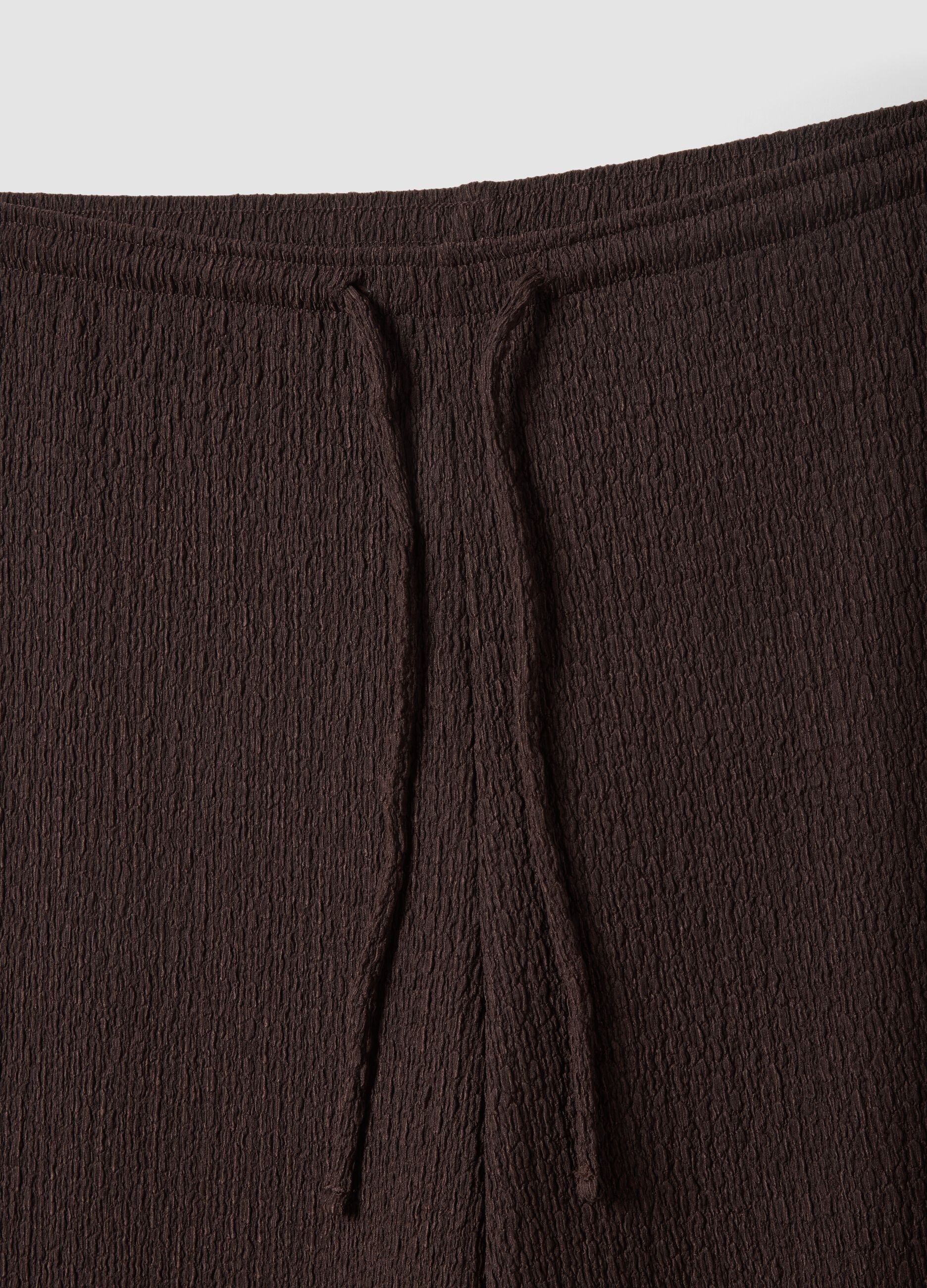 Brown stretch wide-leg trousers with crinkled texture