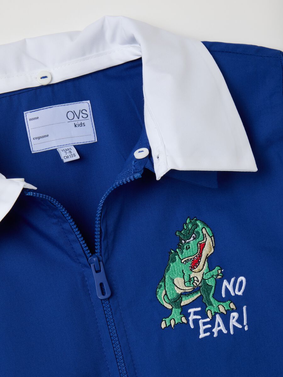 Child's blue cotton blend school apron with dinosaur embroidery_2