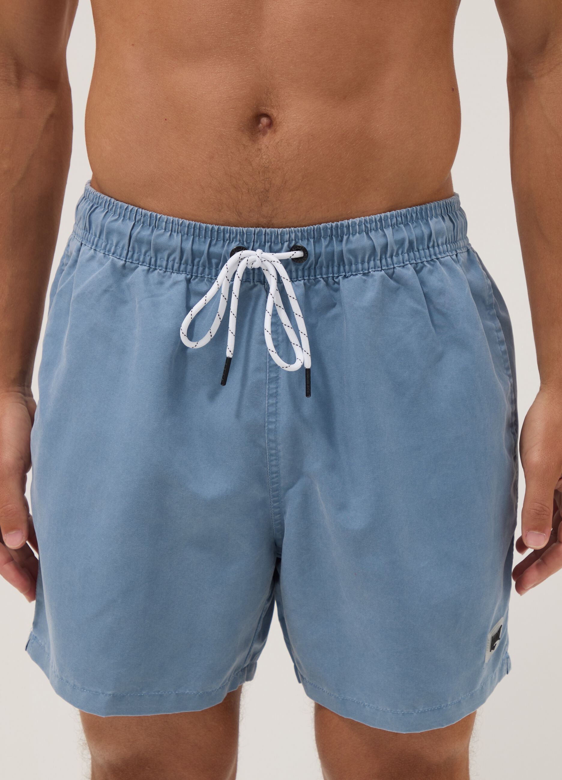 Blue swim shorts with drawstring waist