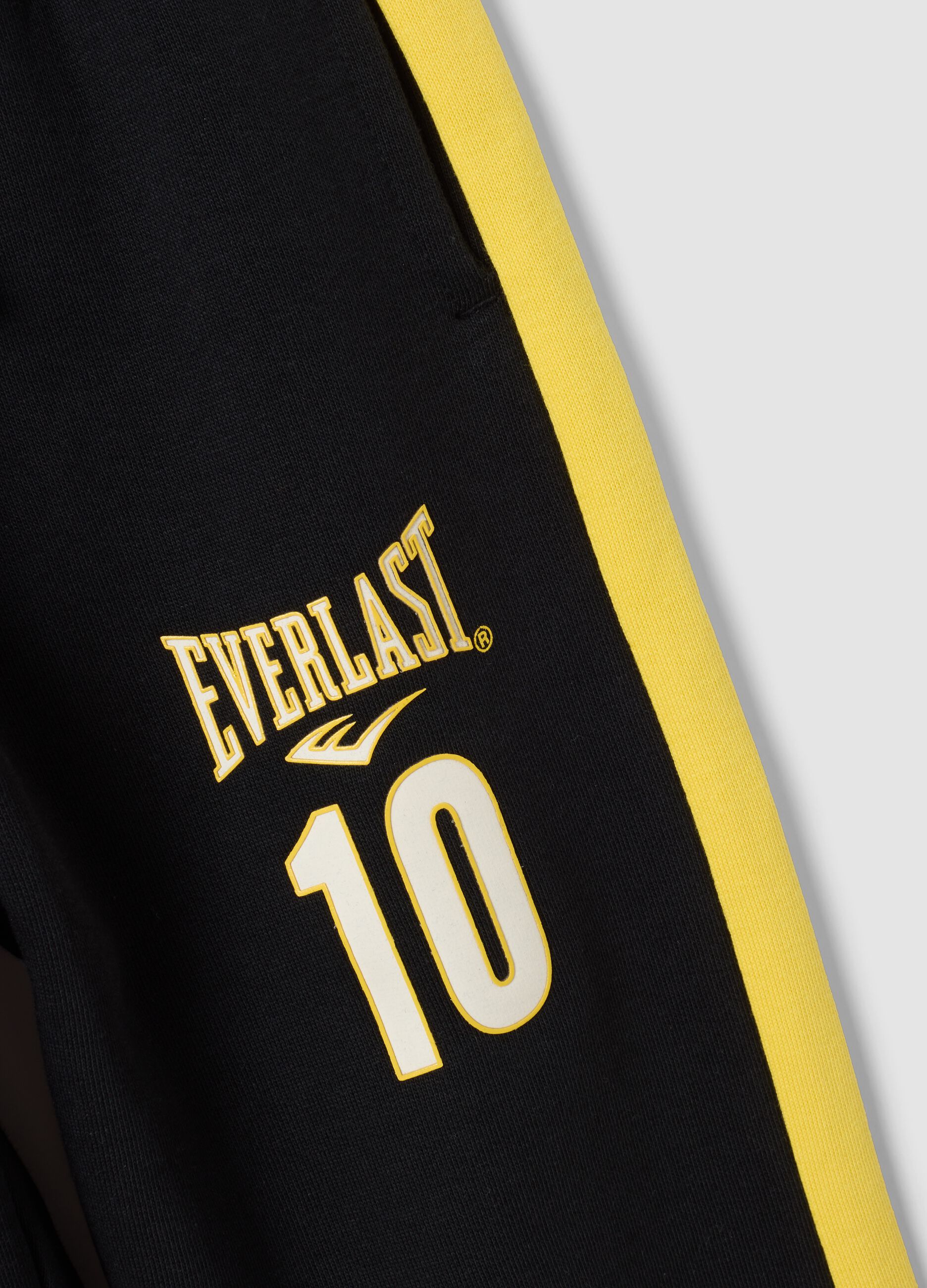 Black 100% cotton kids&rsquo; tracksuit bottoms with yellow side stripes