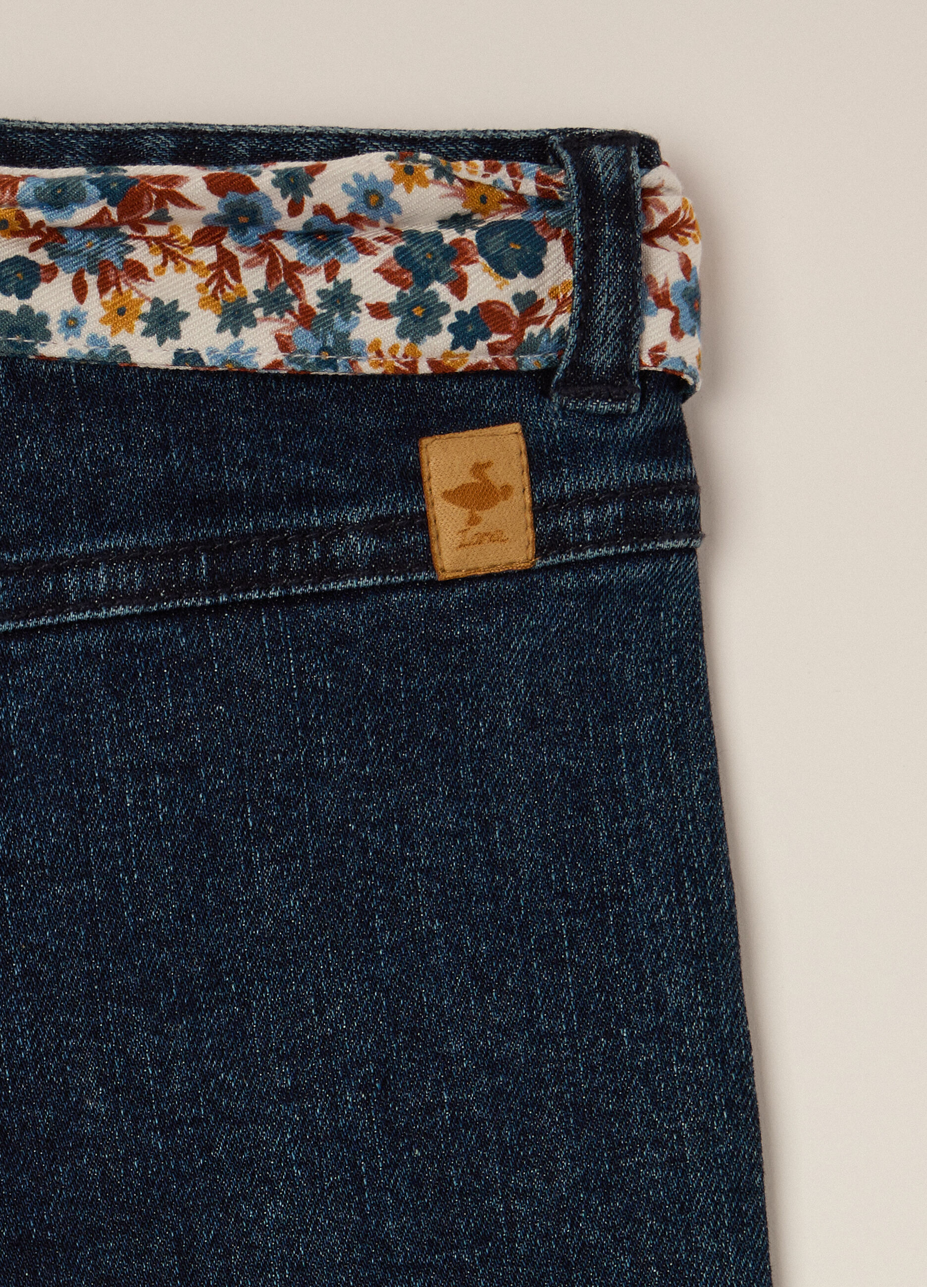 Stretch denim trousers with floral details for girls