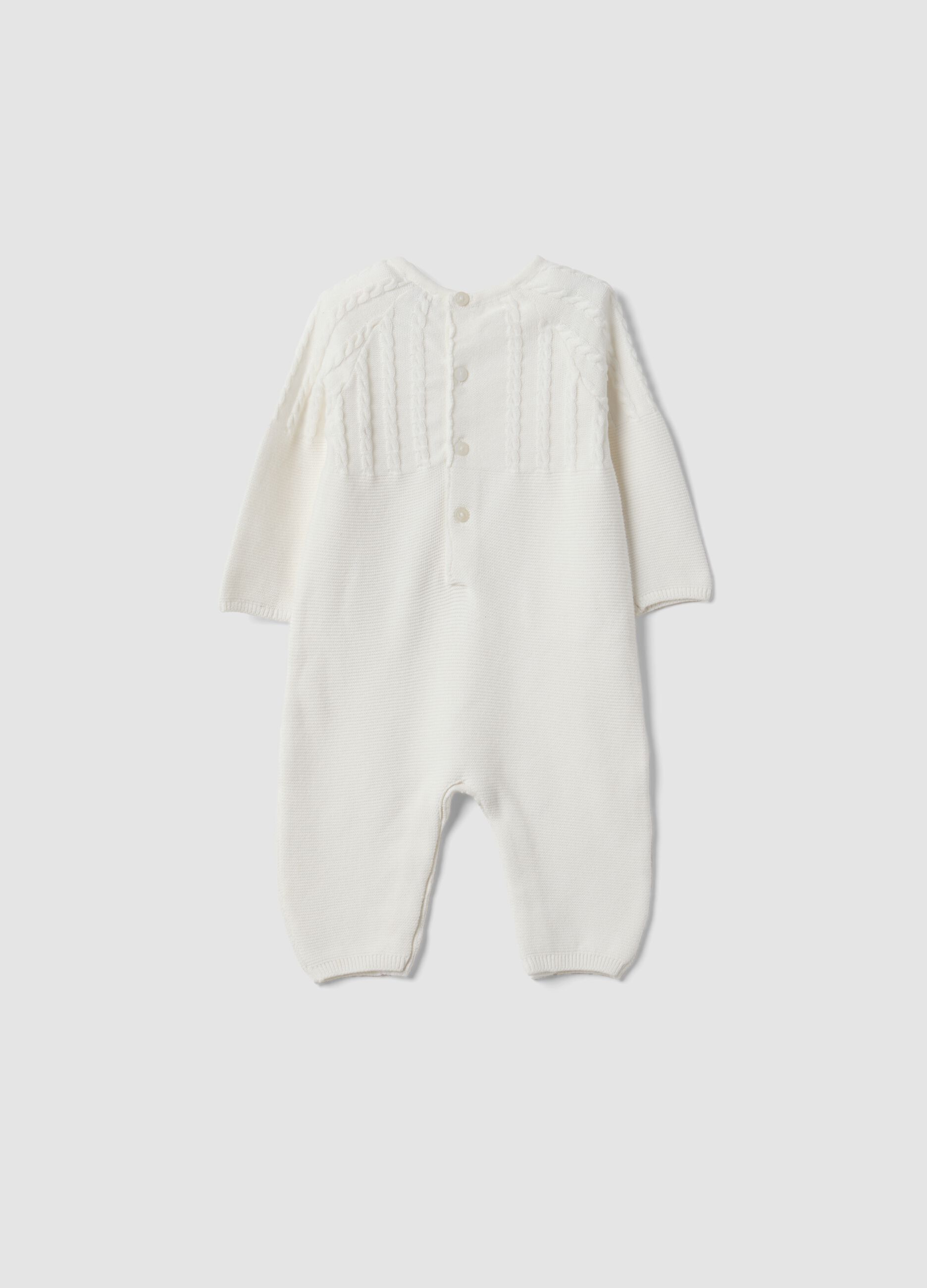 White organic cotton baby sleepsuit with cable knit detail