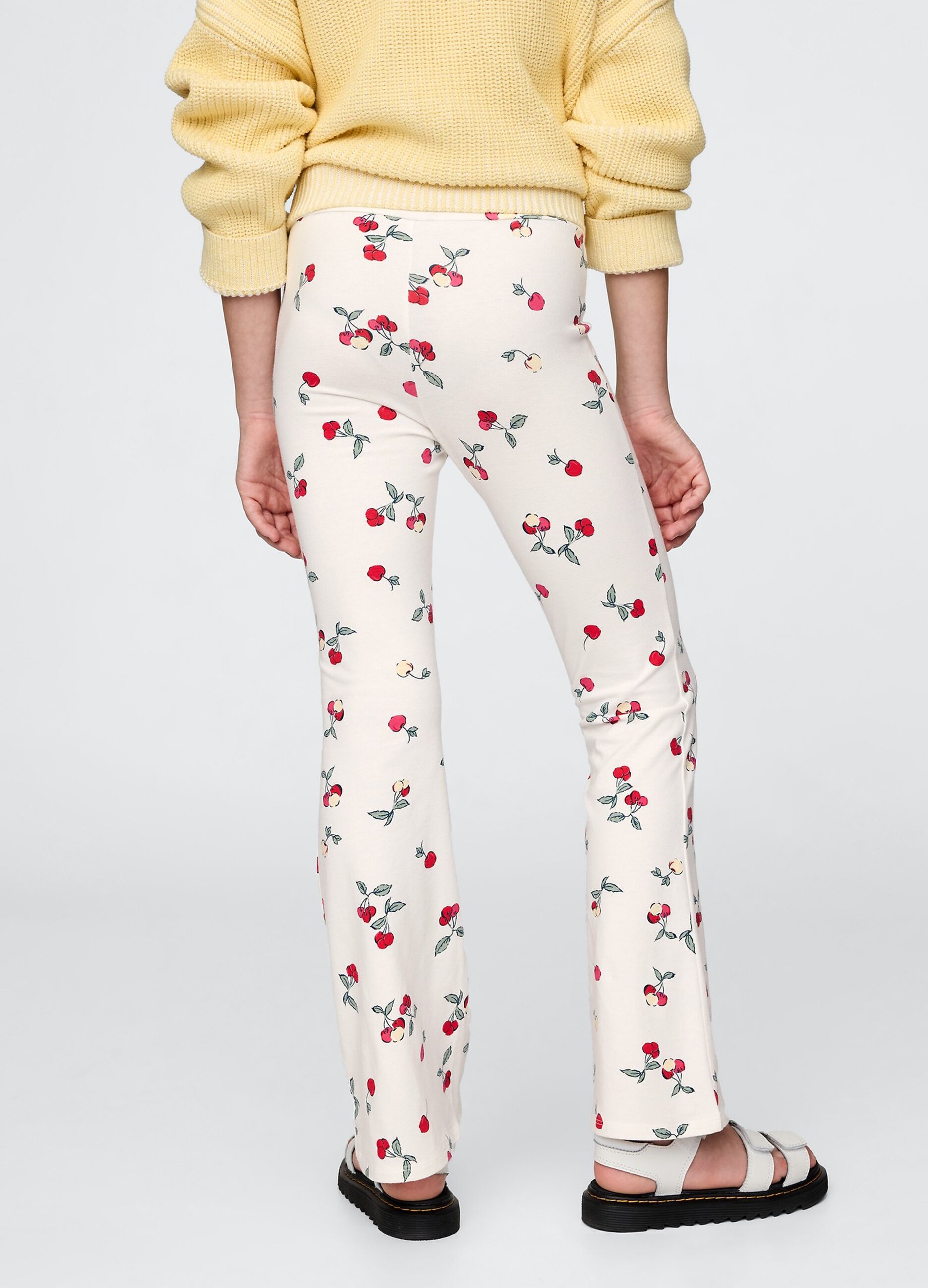 Flared trousers with floral pattern on white background