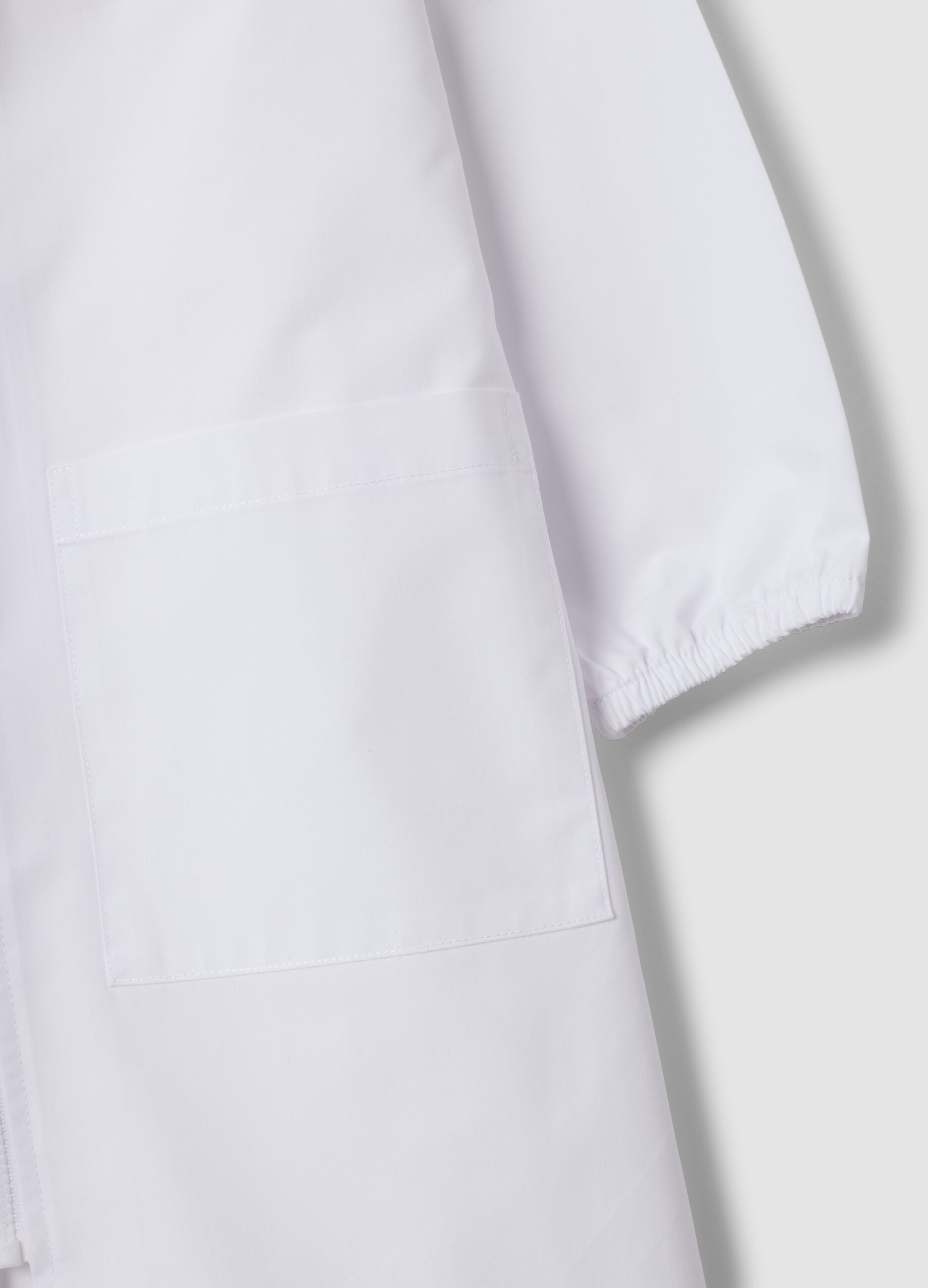 White nursery apron for boys with zip and Spidey embroidery