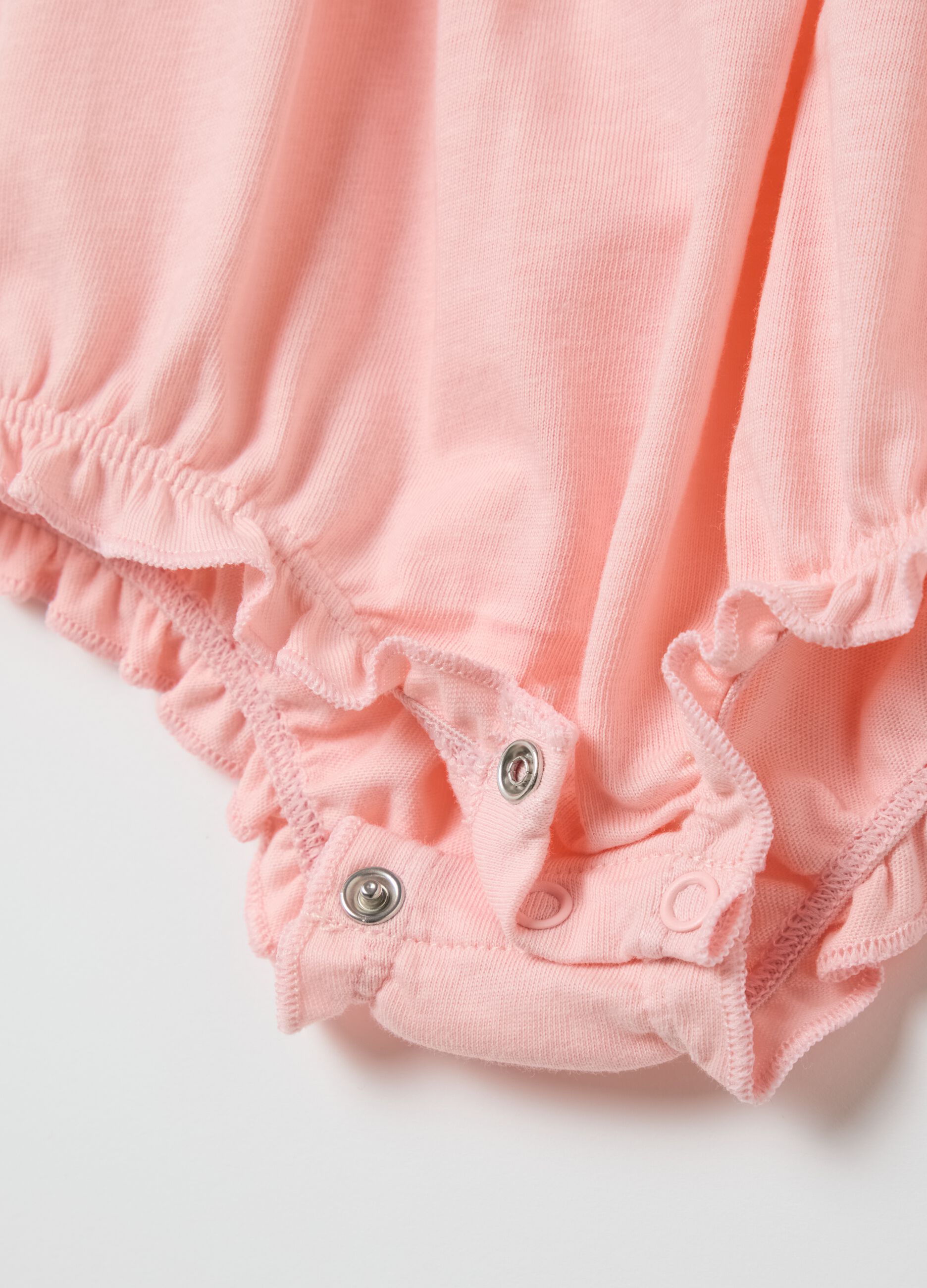 Pink cotton romper with ruffles
