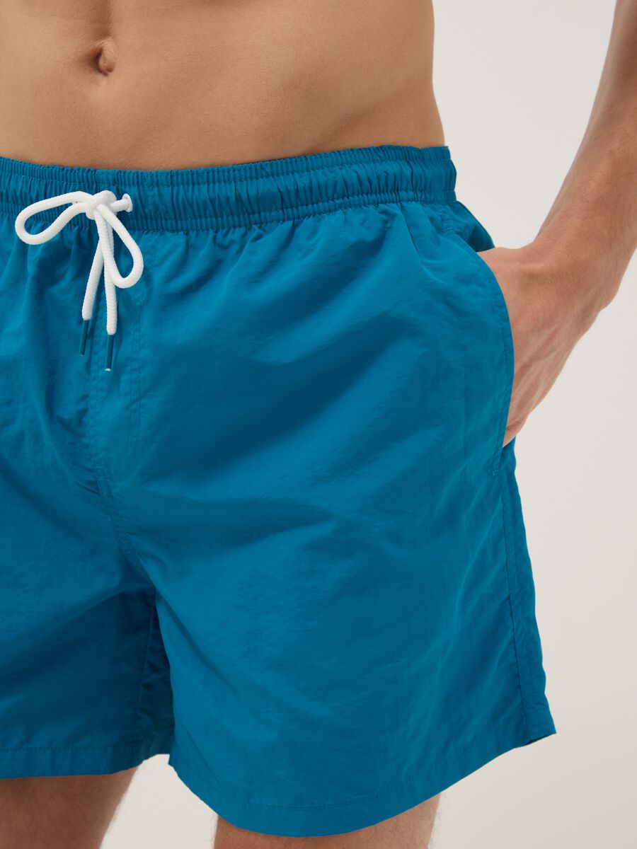 Blue swim shorts with elasticated waist_3