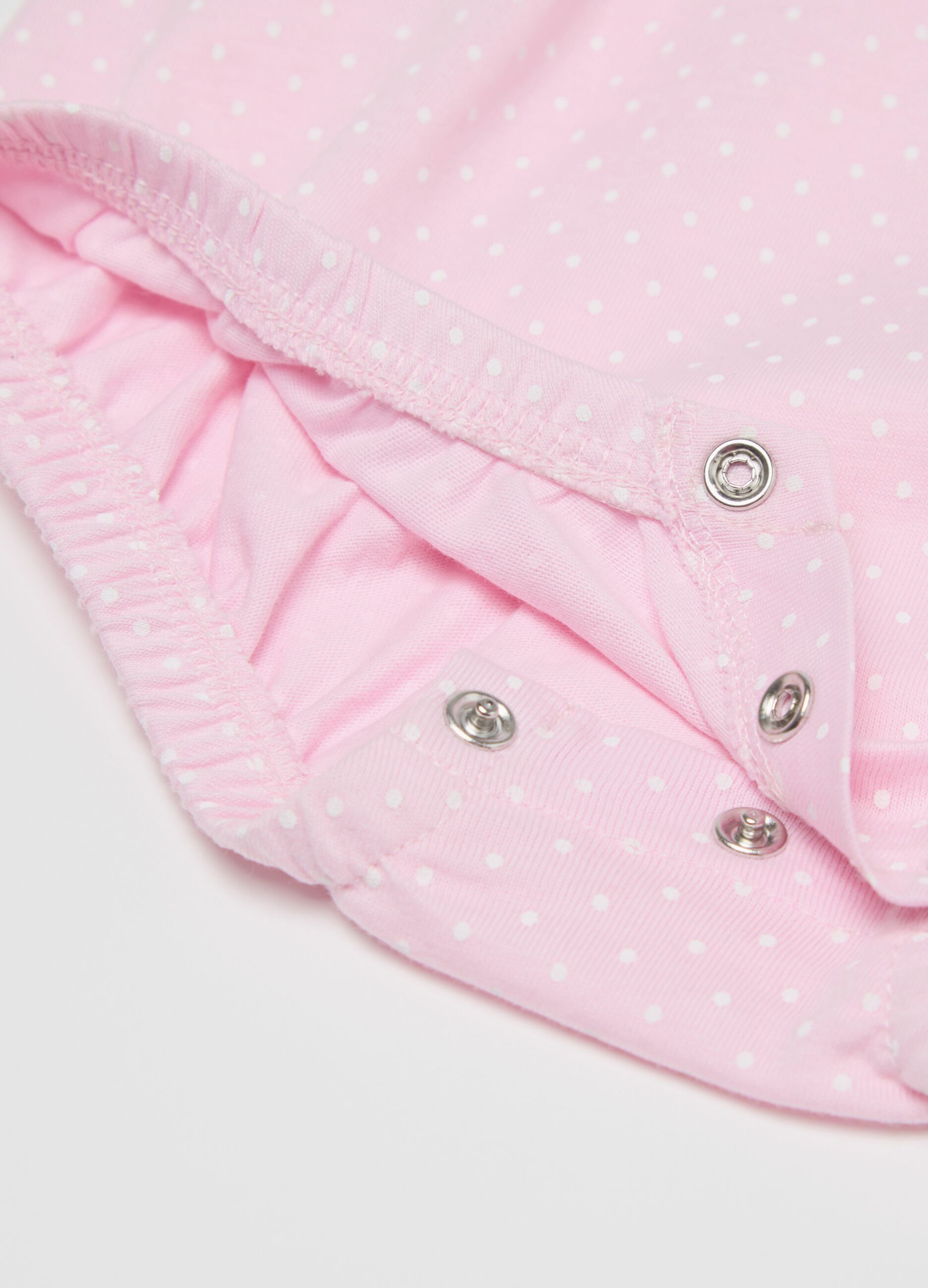 Pink romper suit in organic cotton with micro polka dot pattern