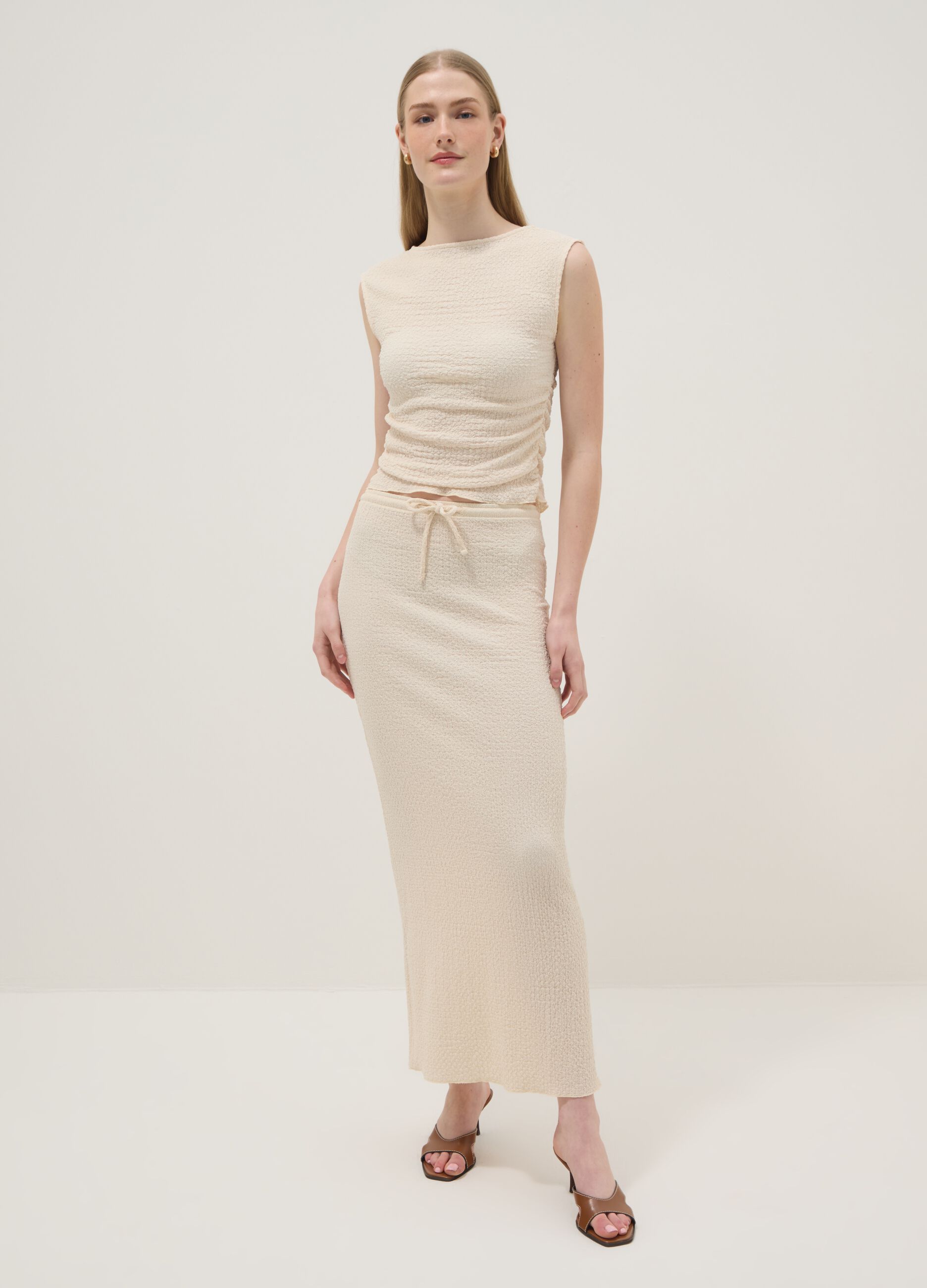 Beige long skirt in stretchy textured fabric