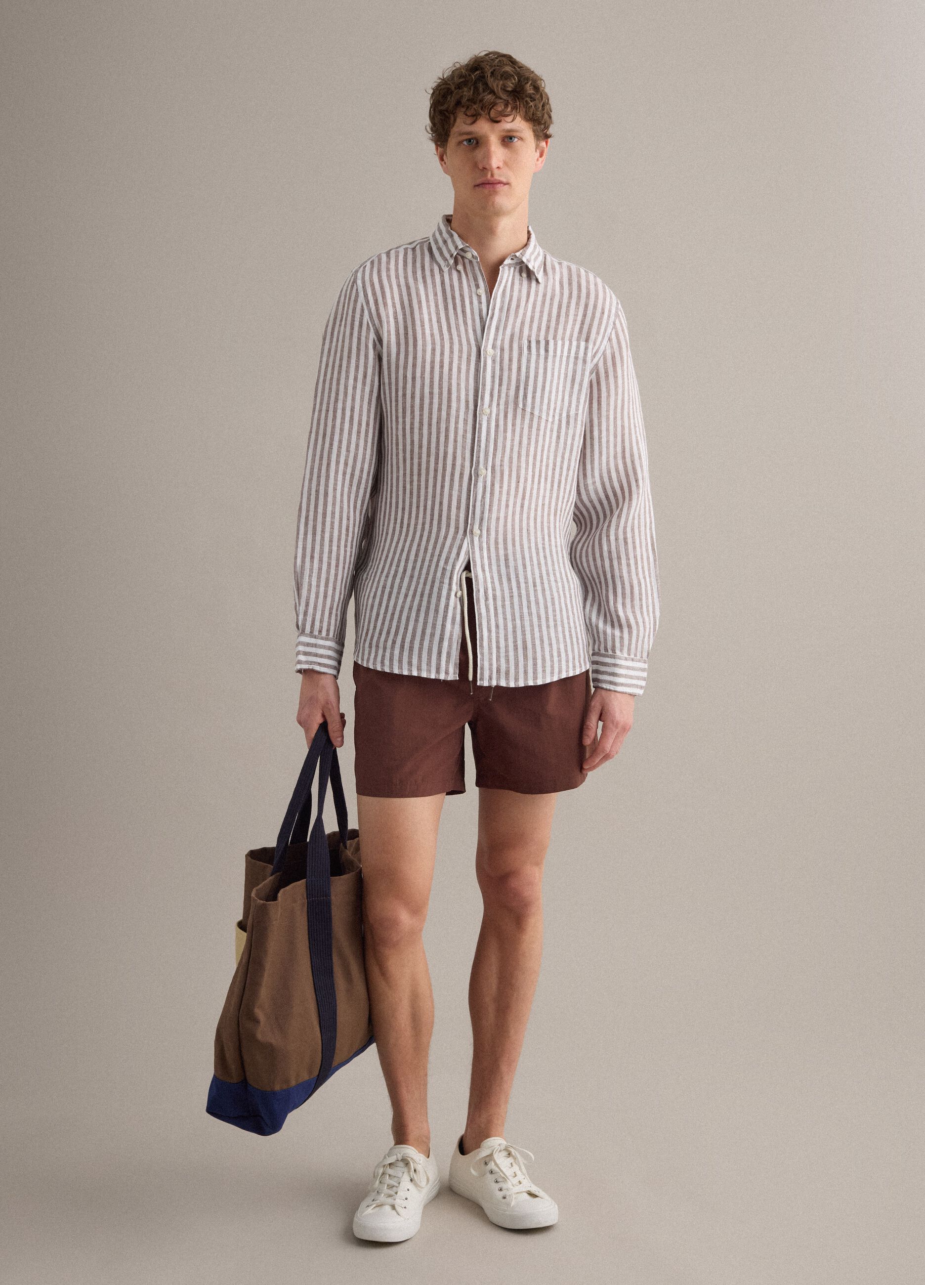 Brown swim shorts with elasticated waistband and drawstring