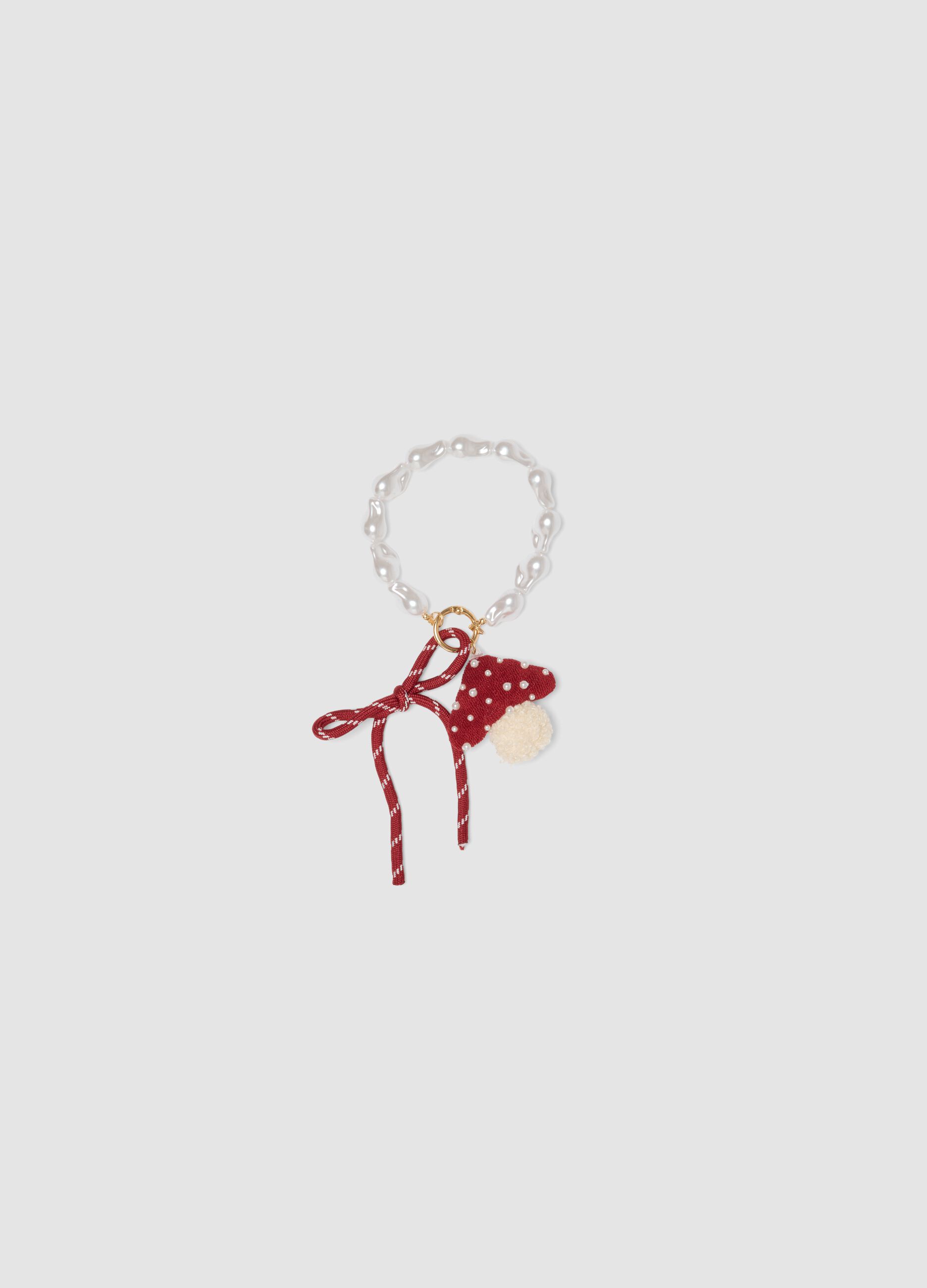 Red bracelet with hat charm and pearls