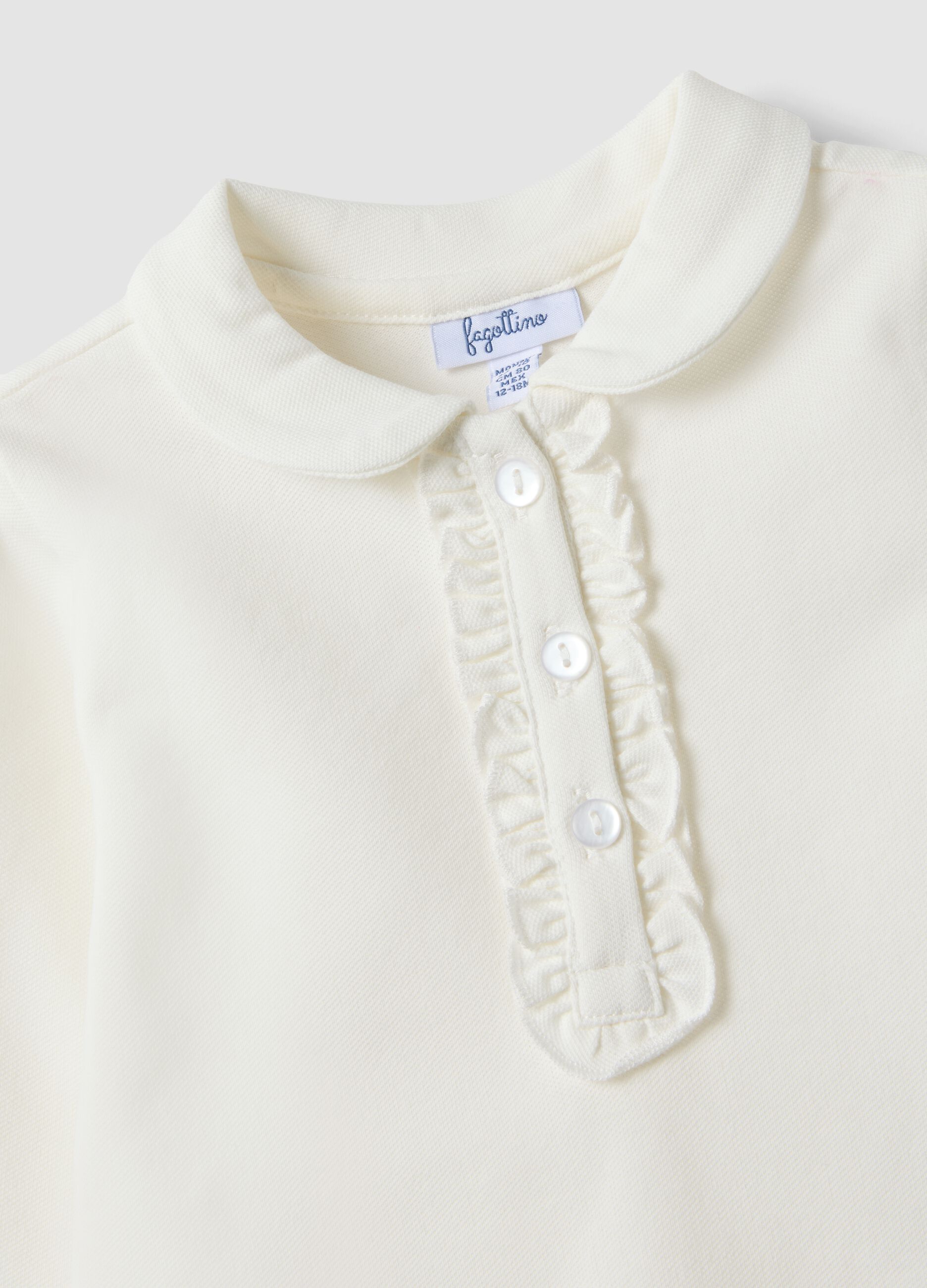 Polo bianca in cotone organico elasticizzato con dettagli volant per bimba