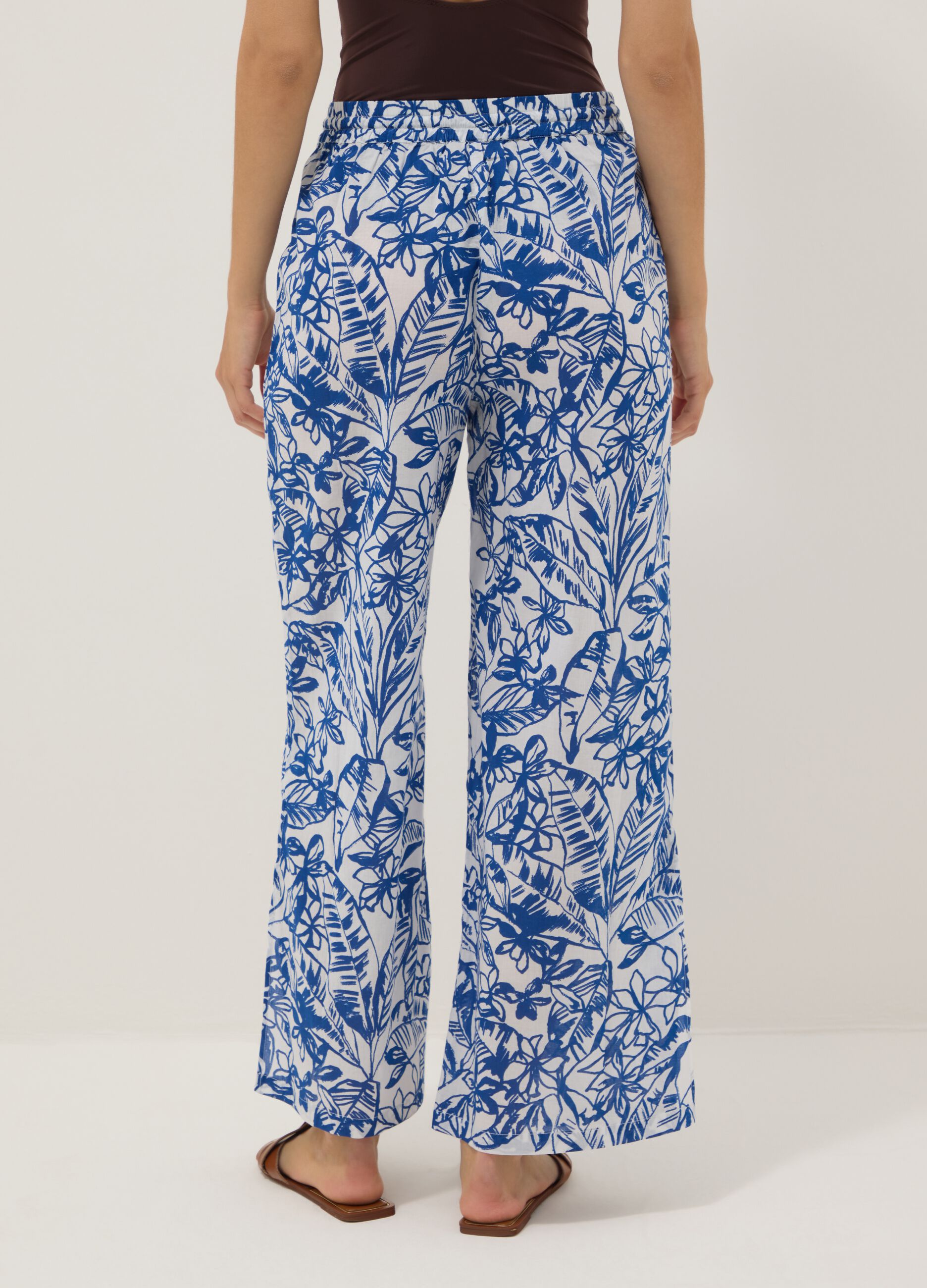 Blue and white organic cotton trousers with floral print