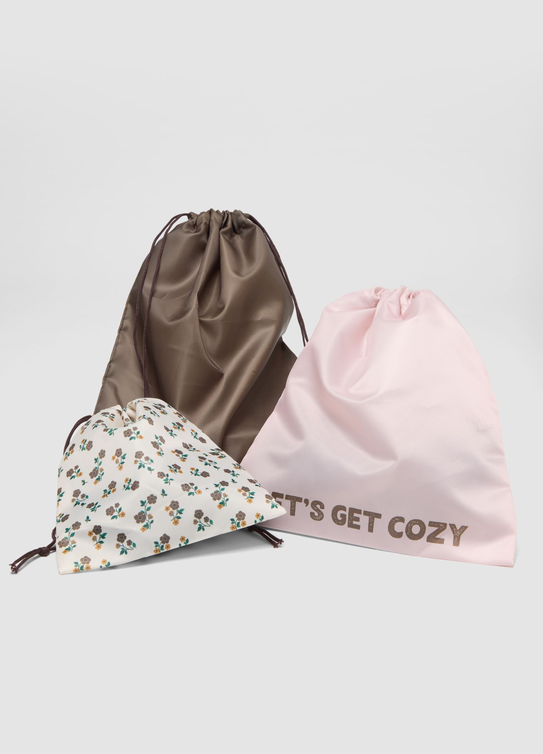 Set of three drawstring pouches in taupe grey, pale pink and off-white