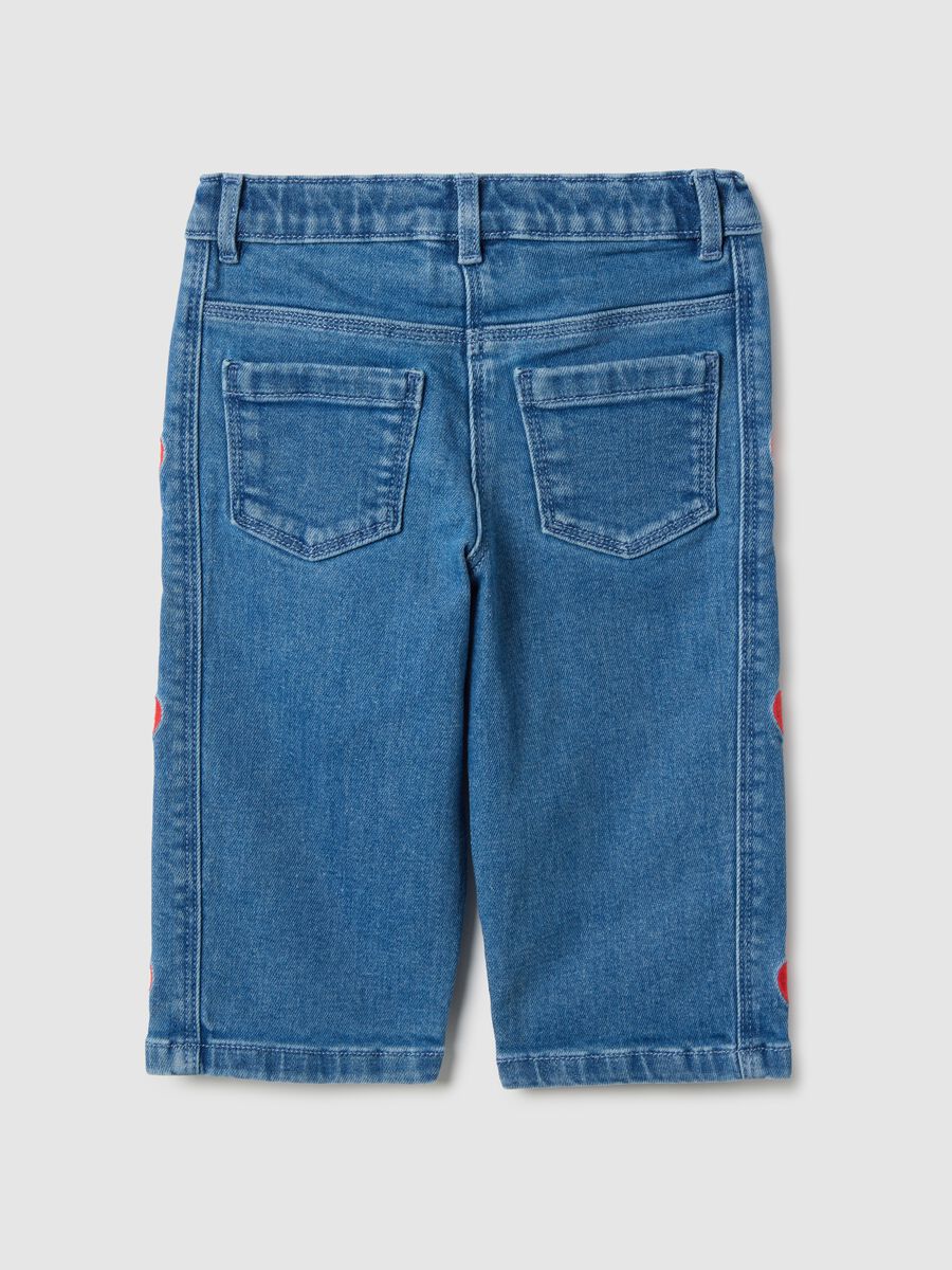 Wide blue denim jeans in cotton blend with embroidered hearts for girls_1