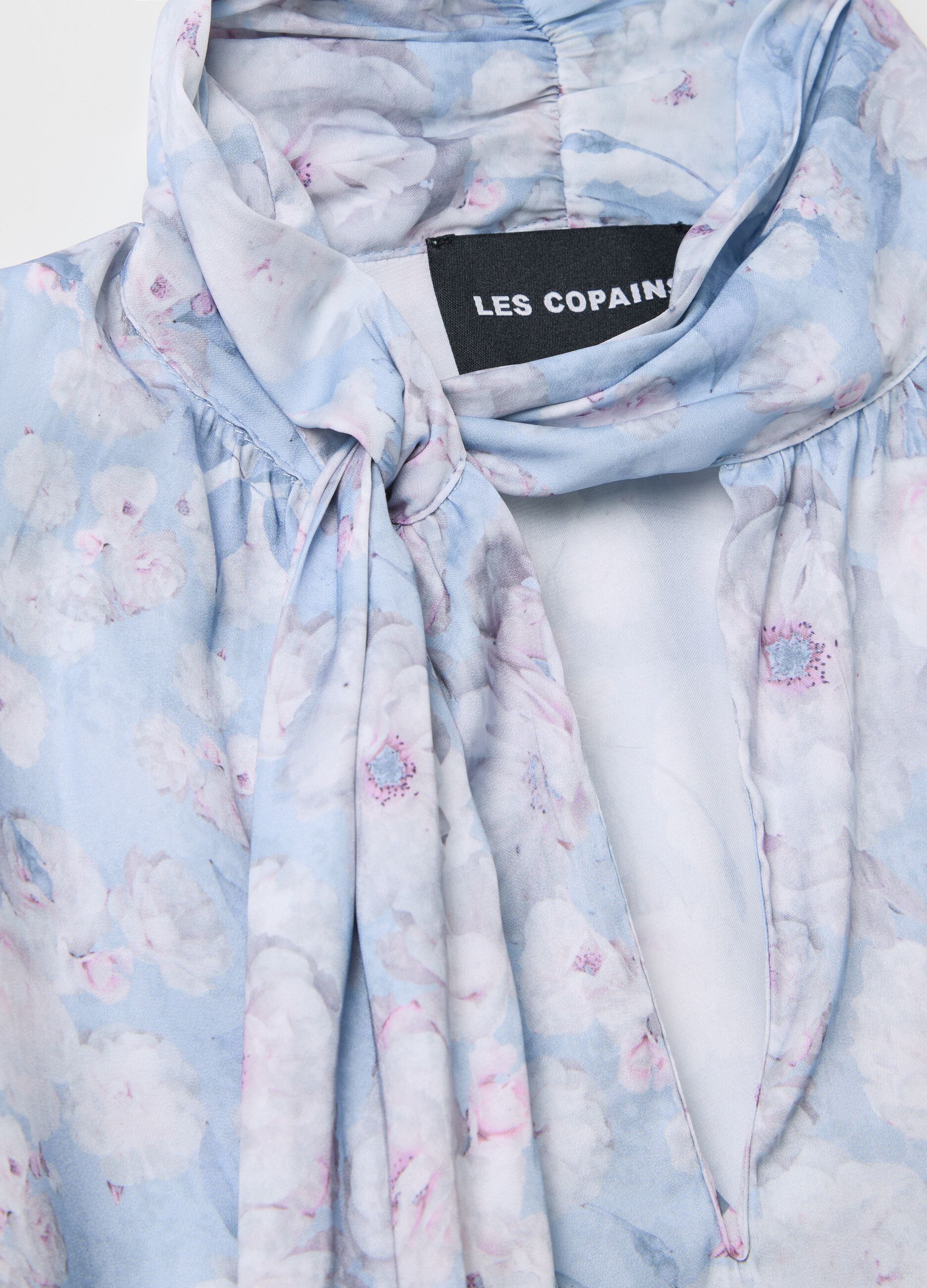 Light blue blouse with floral pattern and bow