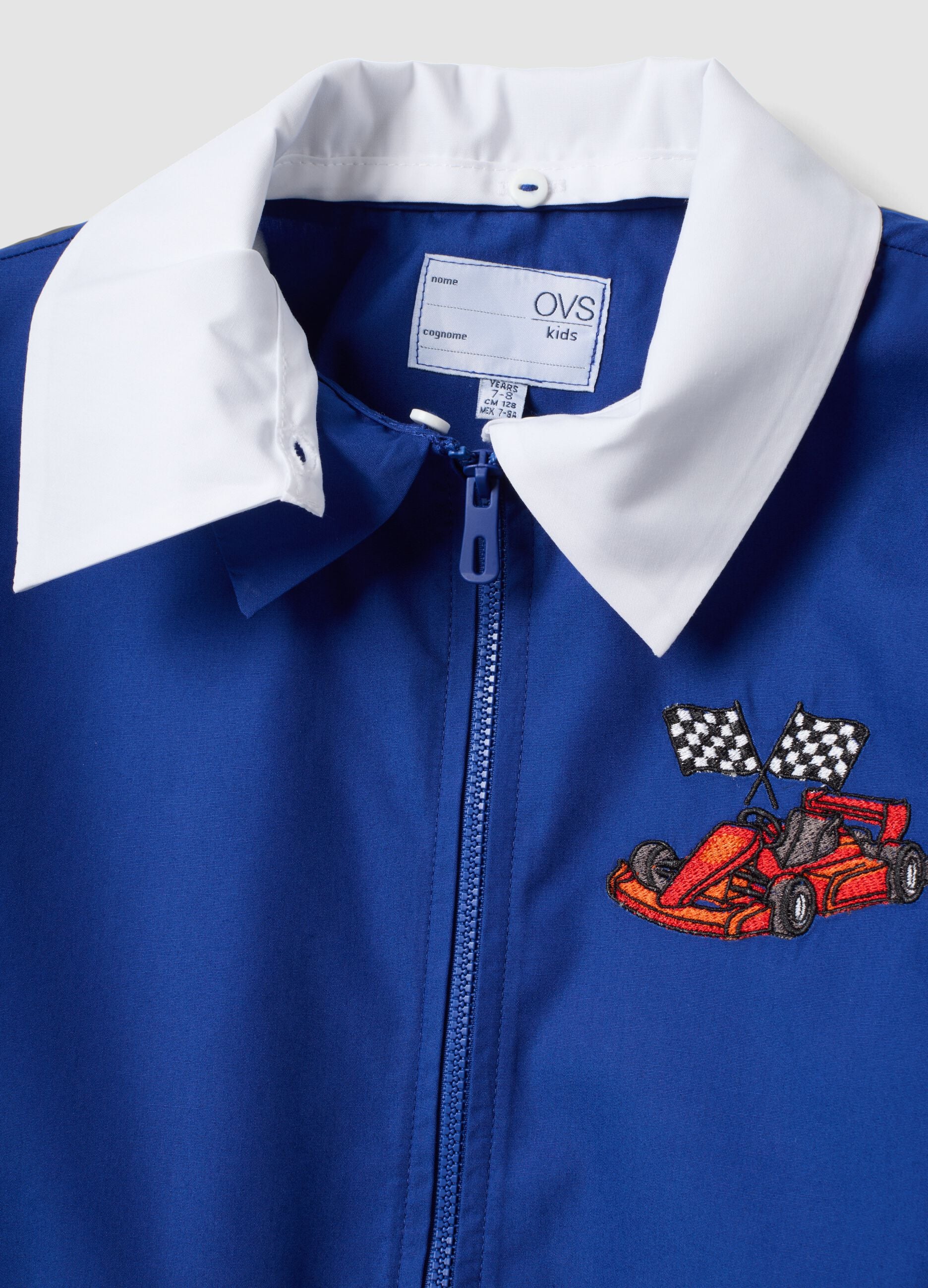 Blue boys&rsquo; school apron with zip and go-kart embroidery