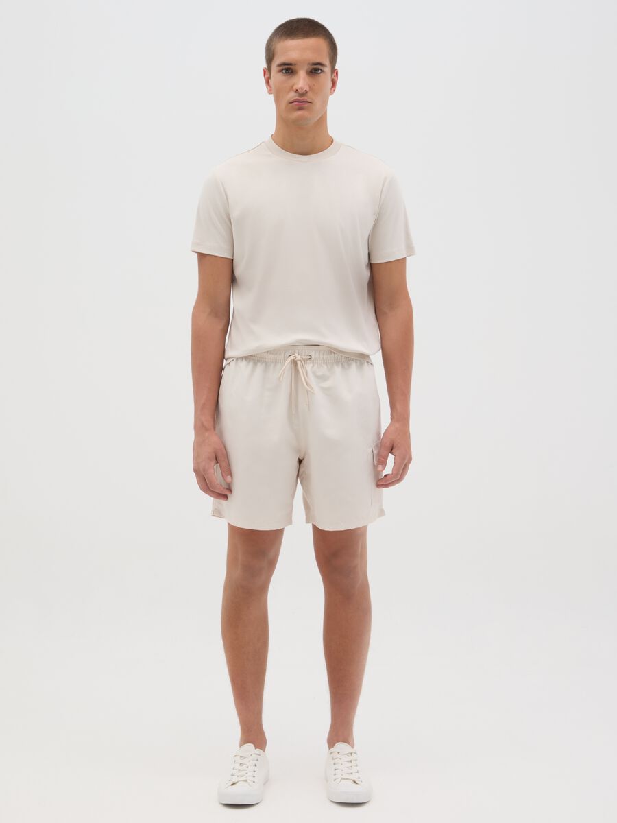Beige swimming trunks with logo print_0