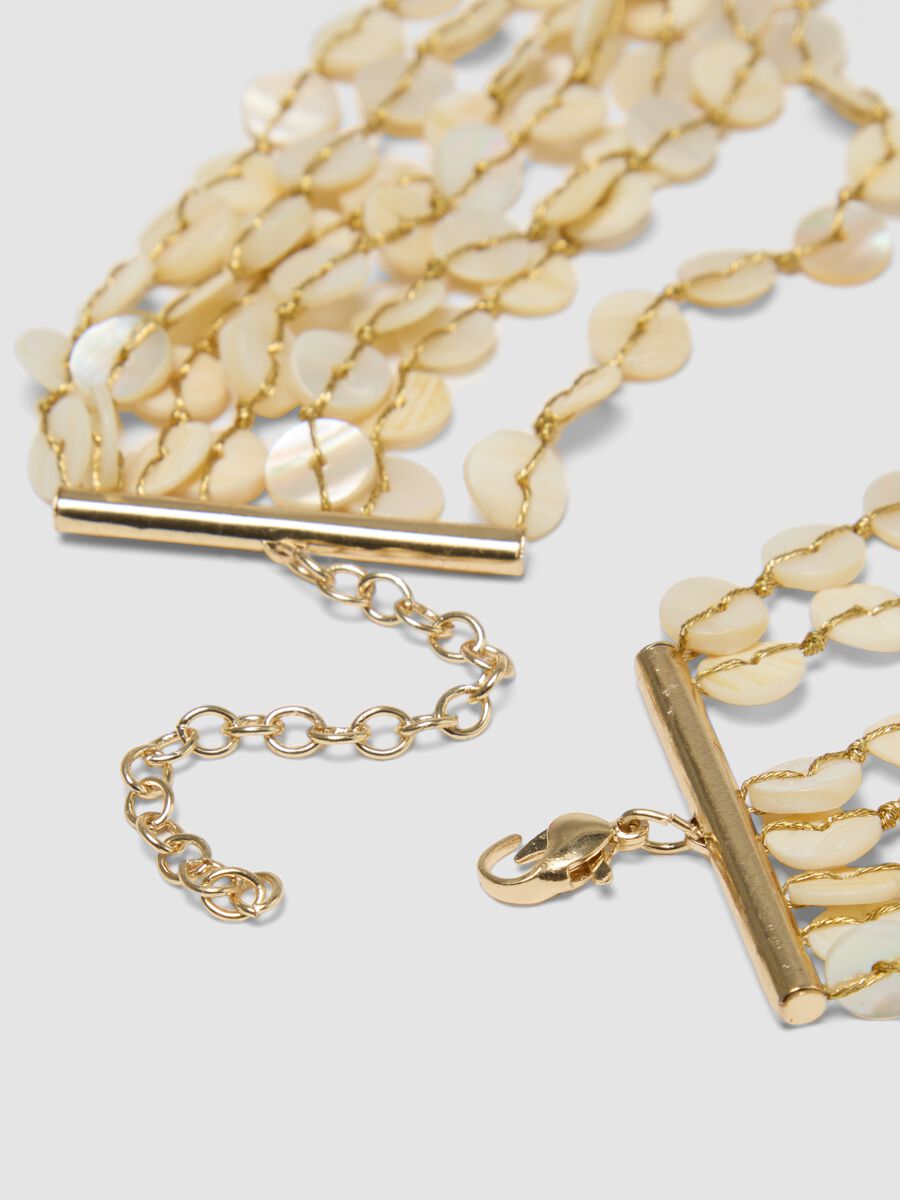 Beige multi-strand necklace with pearlescent discs_1