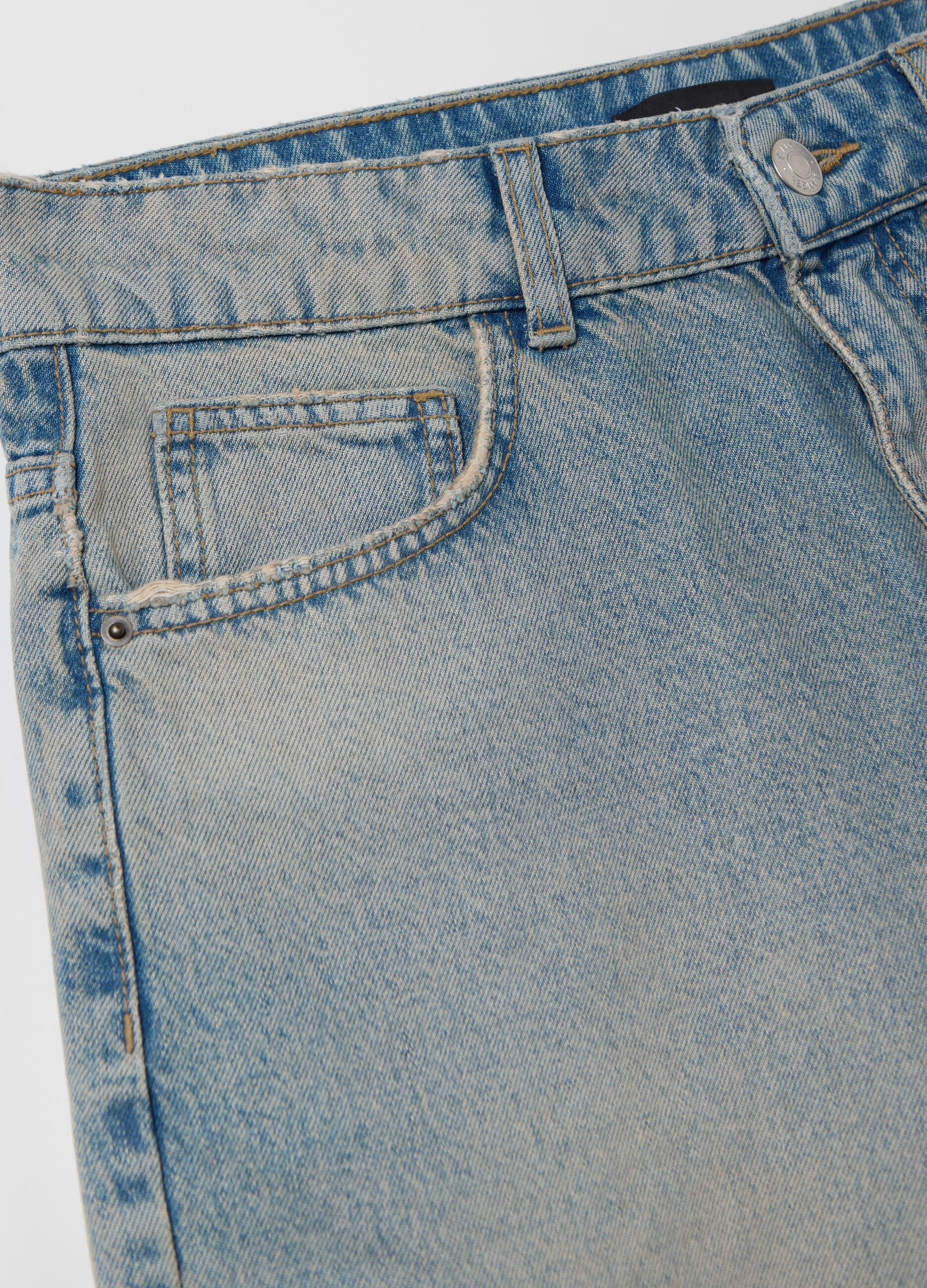 Light blue denim shorts with ripped details