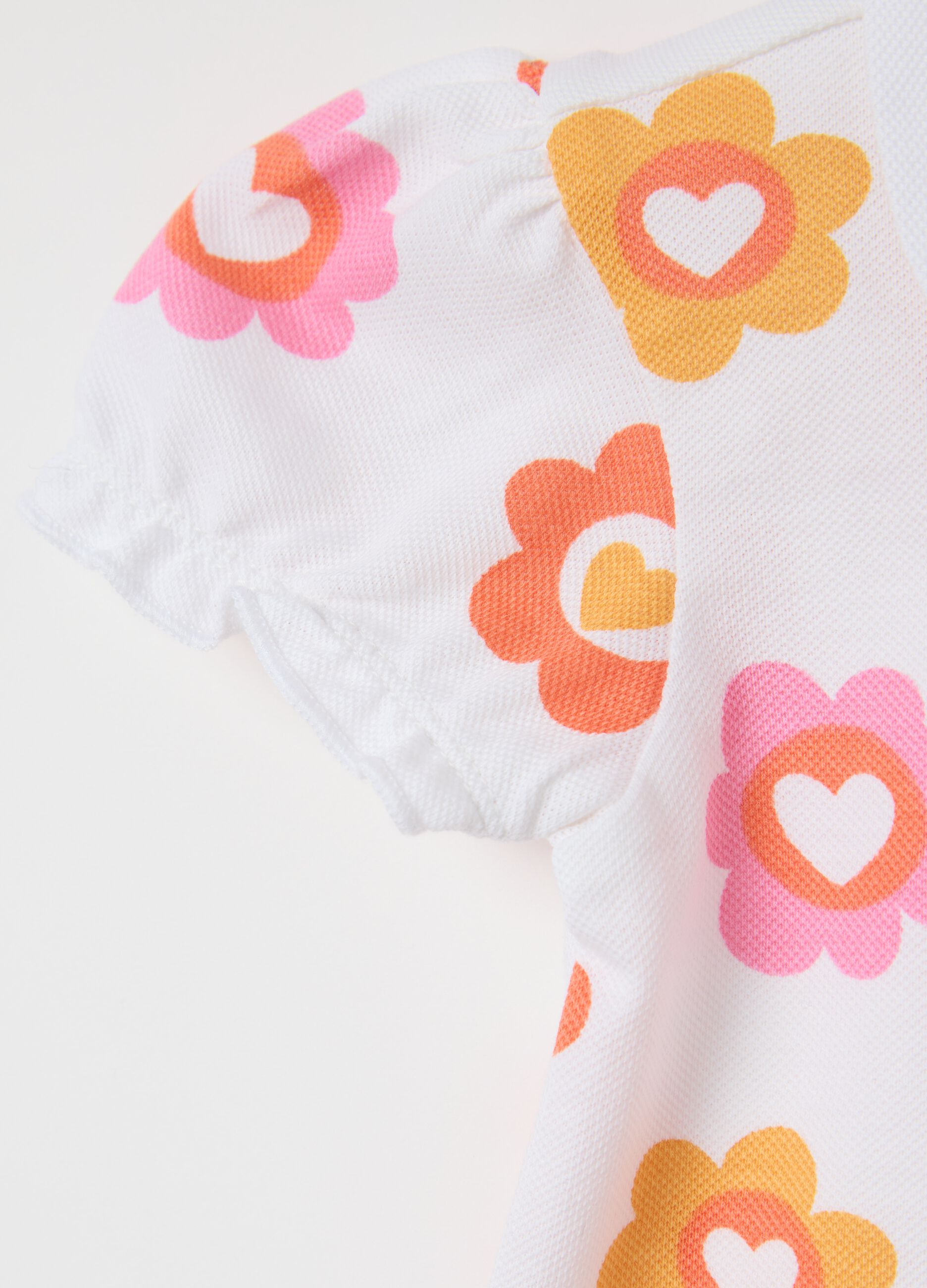 White polo shirt in organic cotton with flowers print
