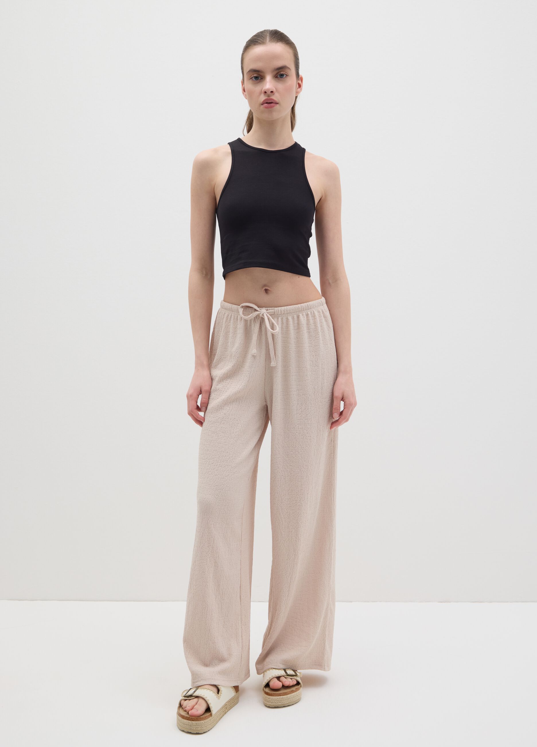 Women's beige regular-fit palazzo pants in stretch fabric.