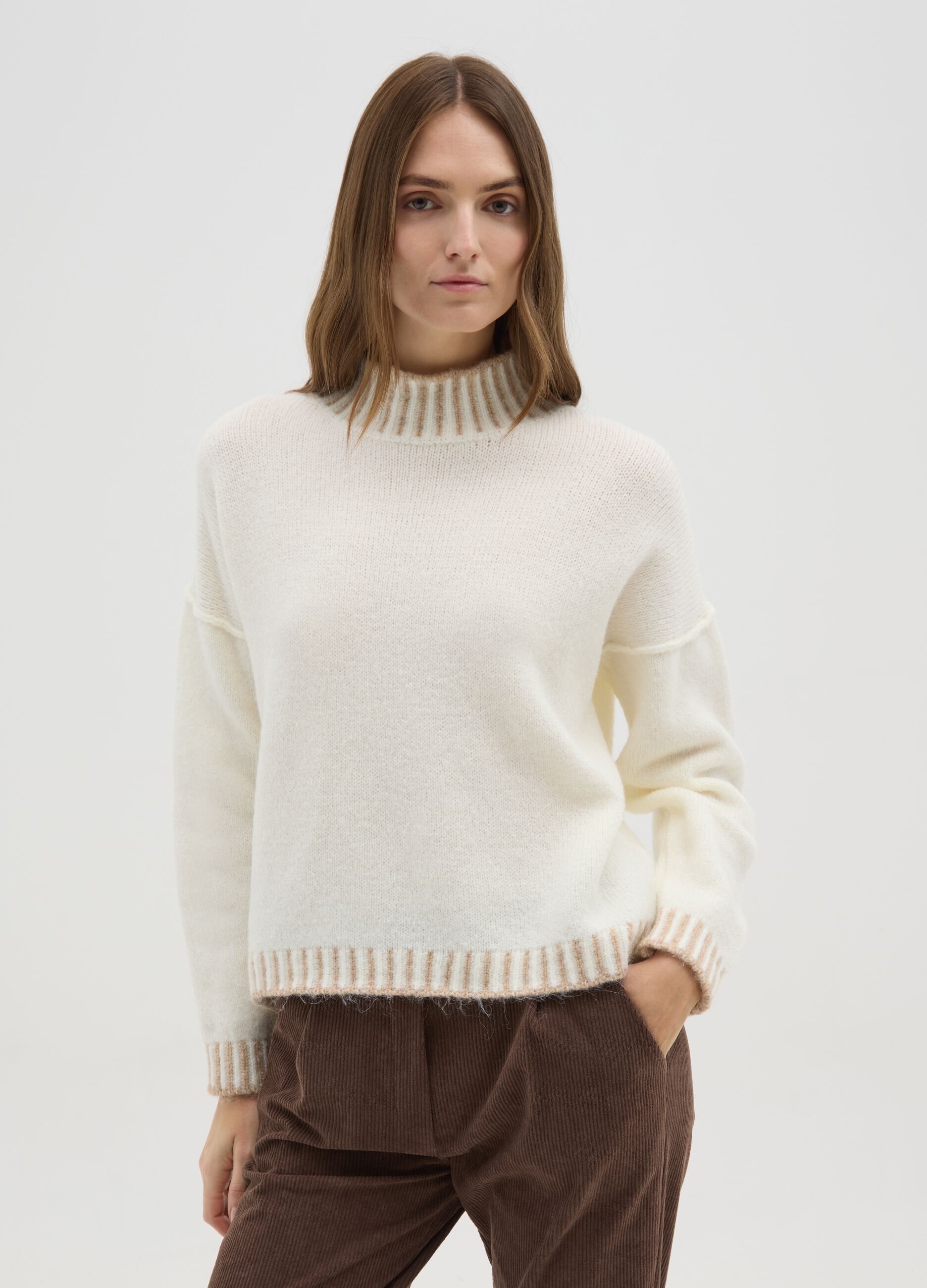 Light beige sweater with high collar and contrasting edges