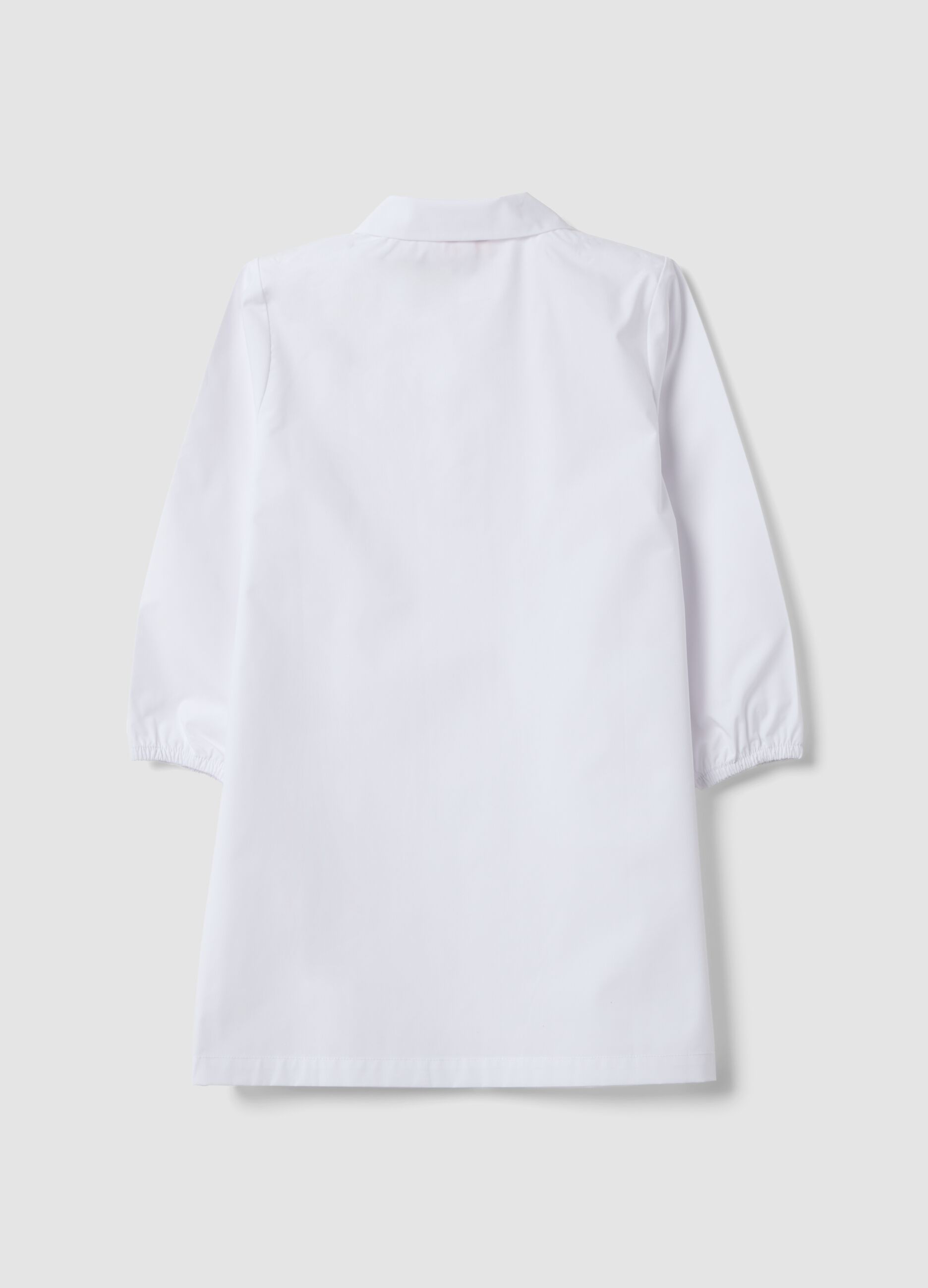 White nursery apron for boys with zip and Spidey embroidery