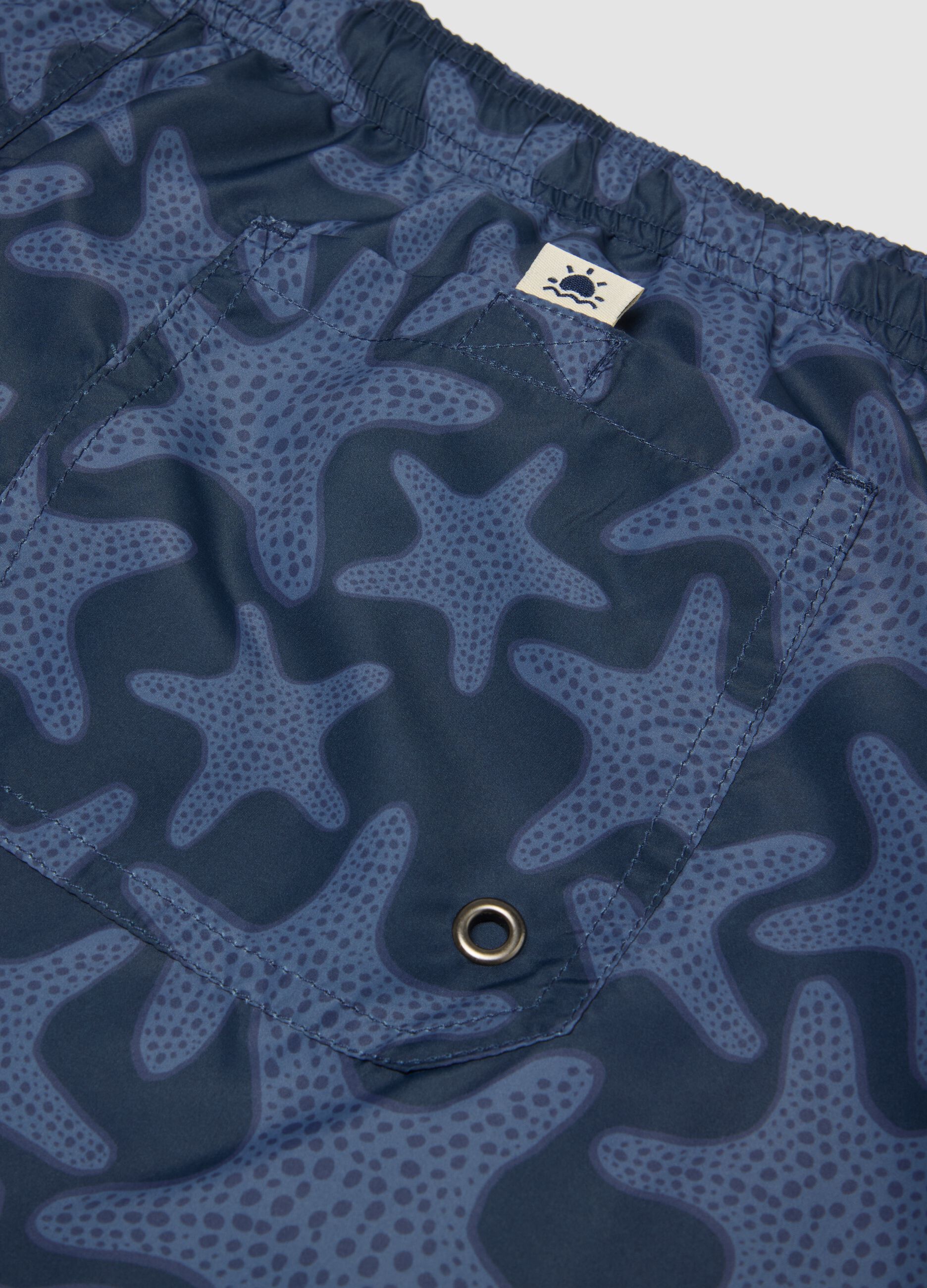 Blue swim shorts with starfish print
