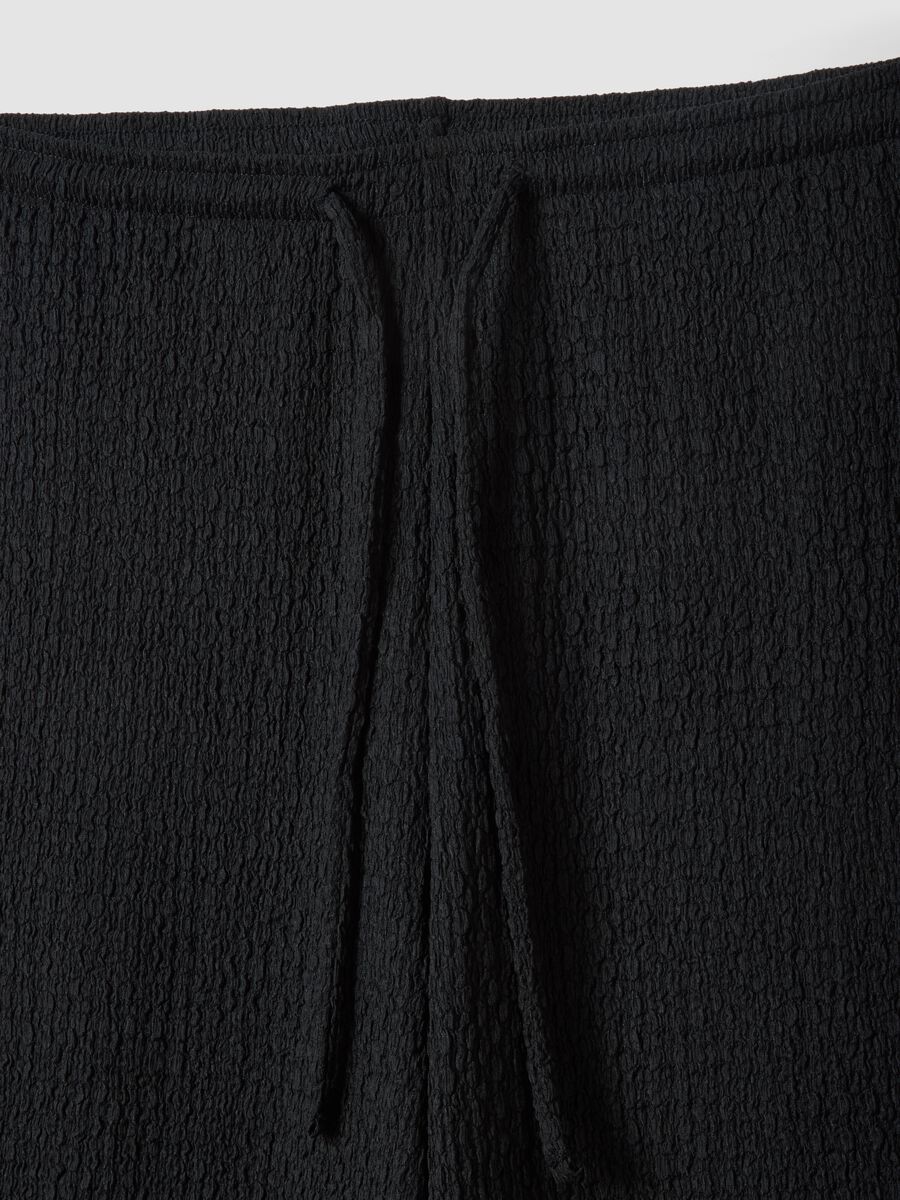 Black stretchy wide-leg trousers with crinkled texture_1