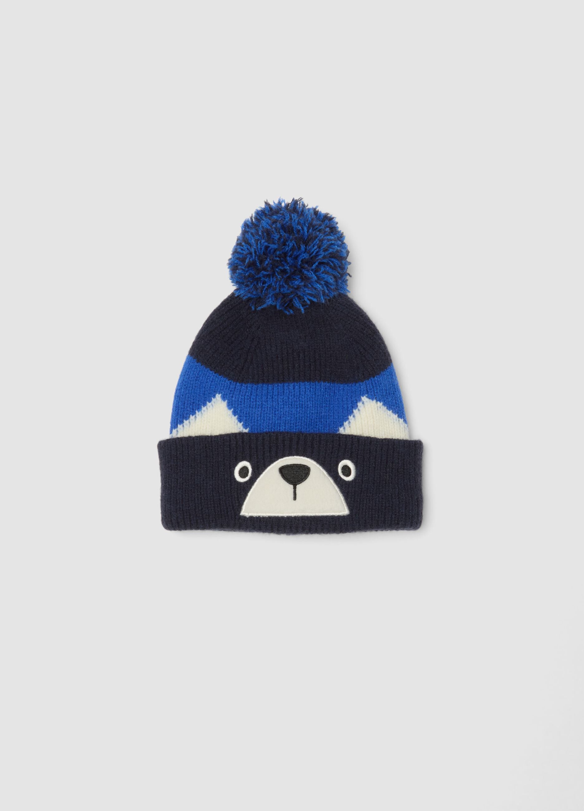 Blue knitted hat with pom-pom and animal motif