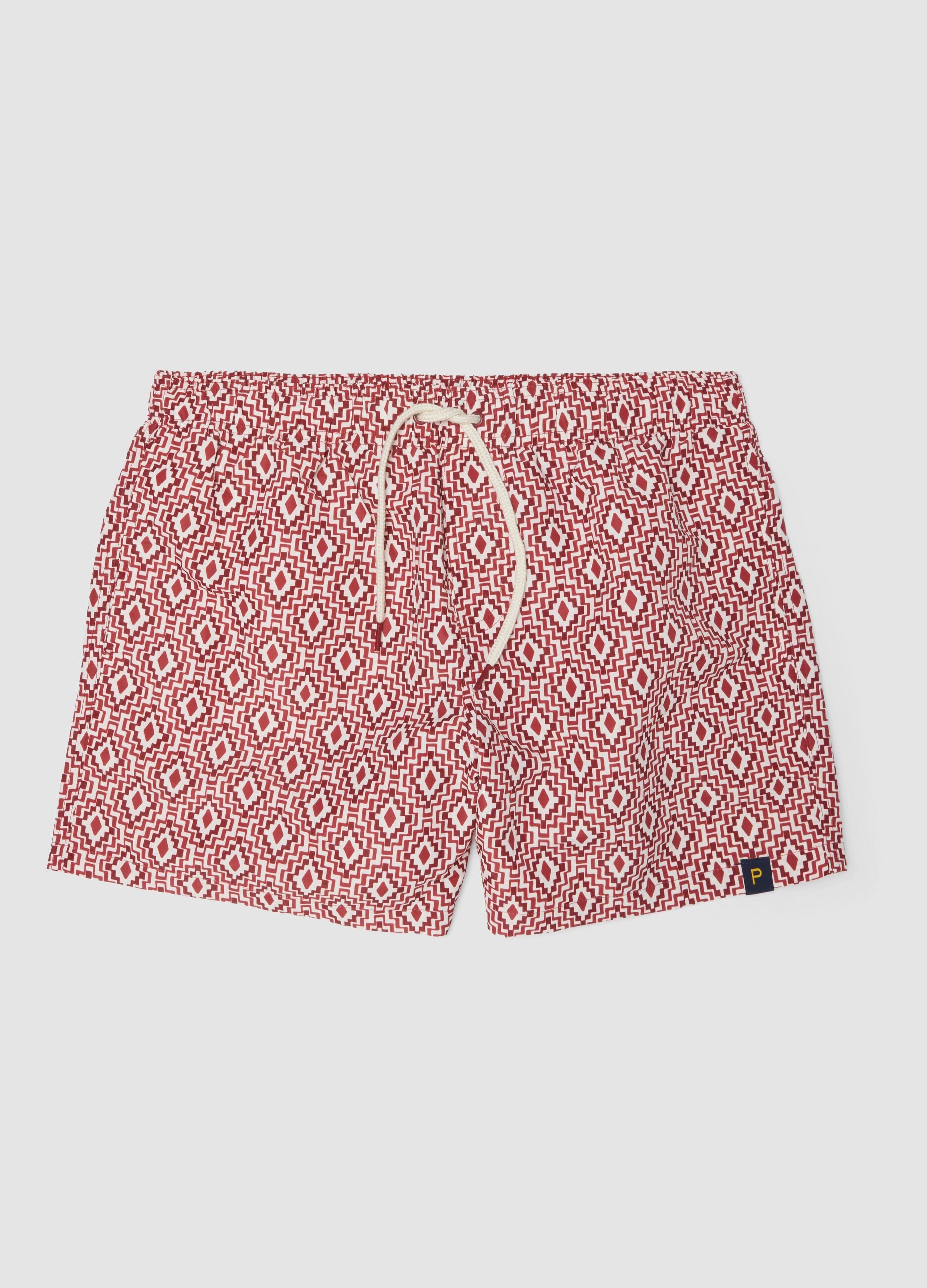 Red swim shorts with geometric print