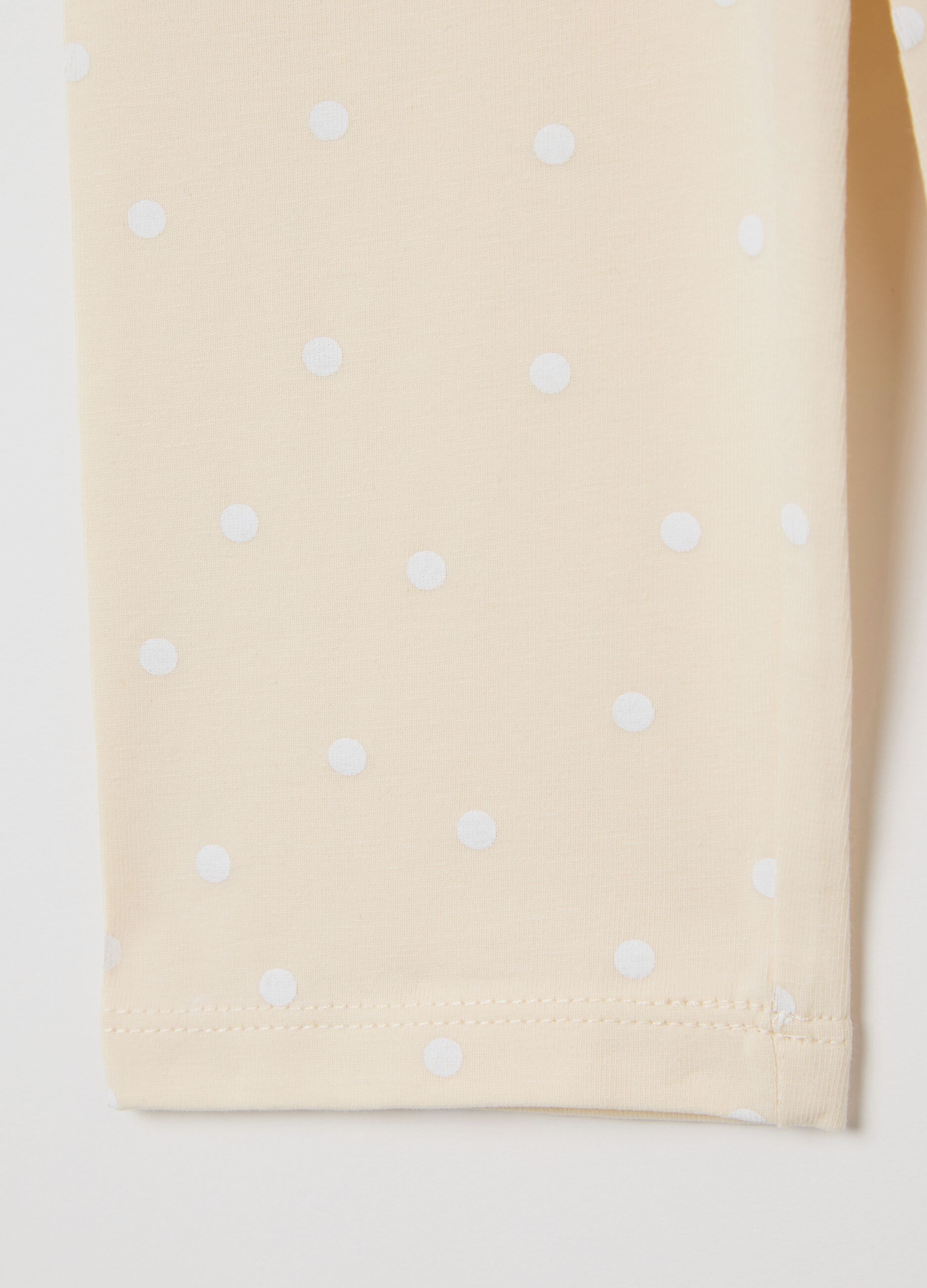 Beige three-quarter leggings with polka dot pattern